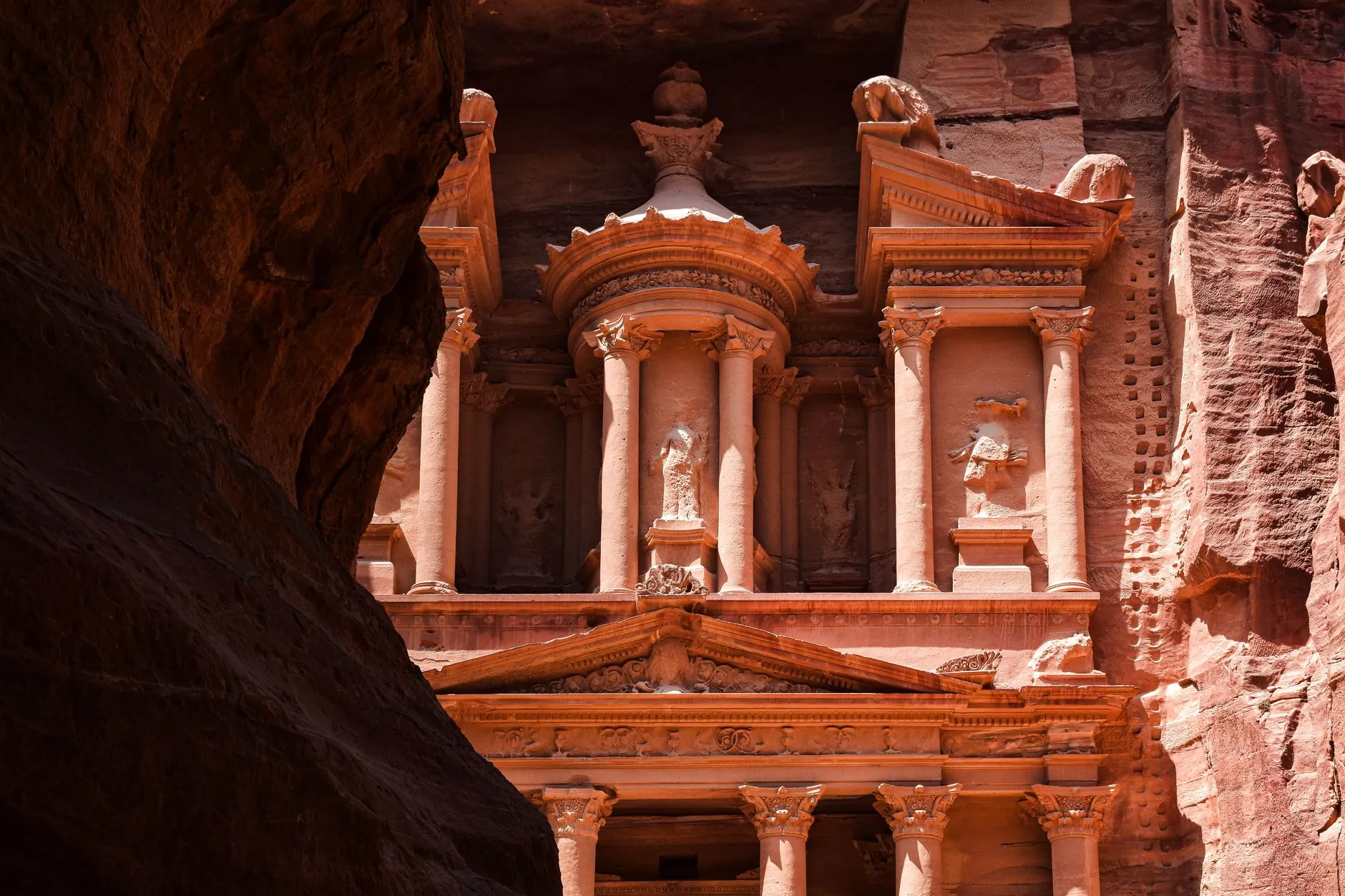 Queen Alia Airport (AMM) — Iconic view of The Treasury in Petra, an ancient Nabatean city carved in pink sandstone rock.