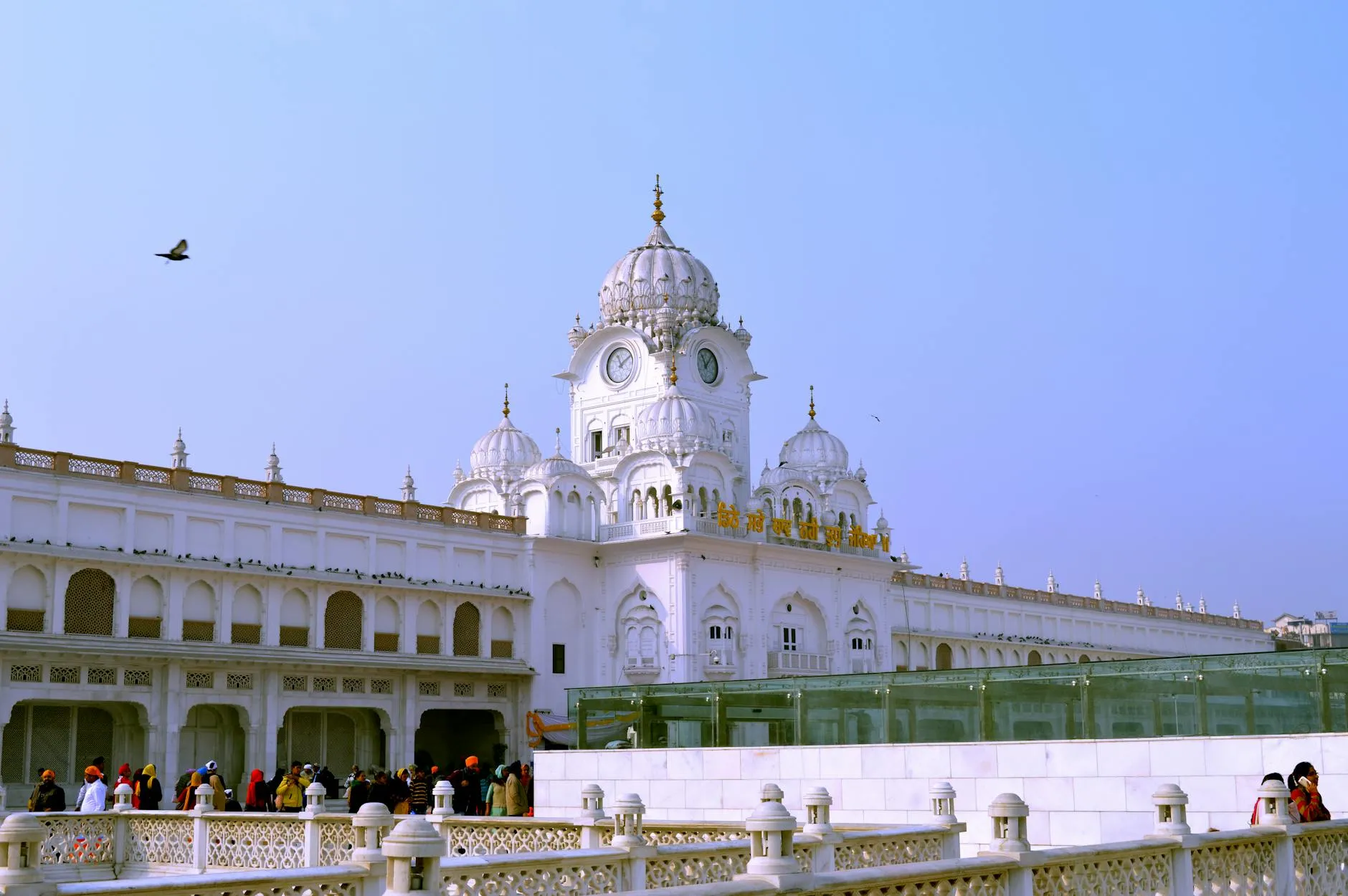 Amritsar, India — Tourists visit iconic Harmandir Sahib, part of the Golden Temple in Amritsar, Punjab, India, a renowned Sikh landmark.