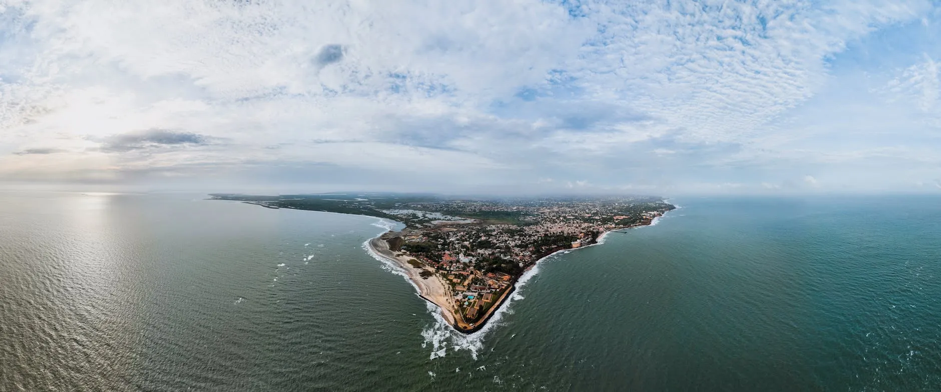 Stunning aerial view of Banjul, The Gambia's scenic coastline under a cloudy sky.