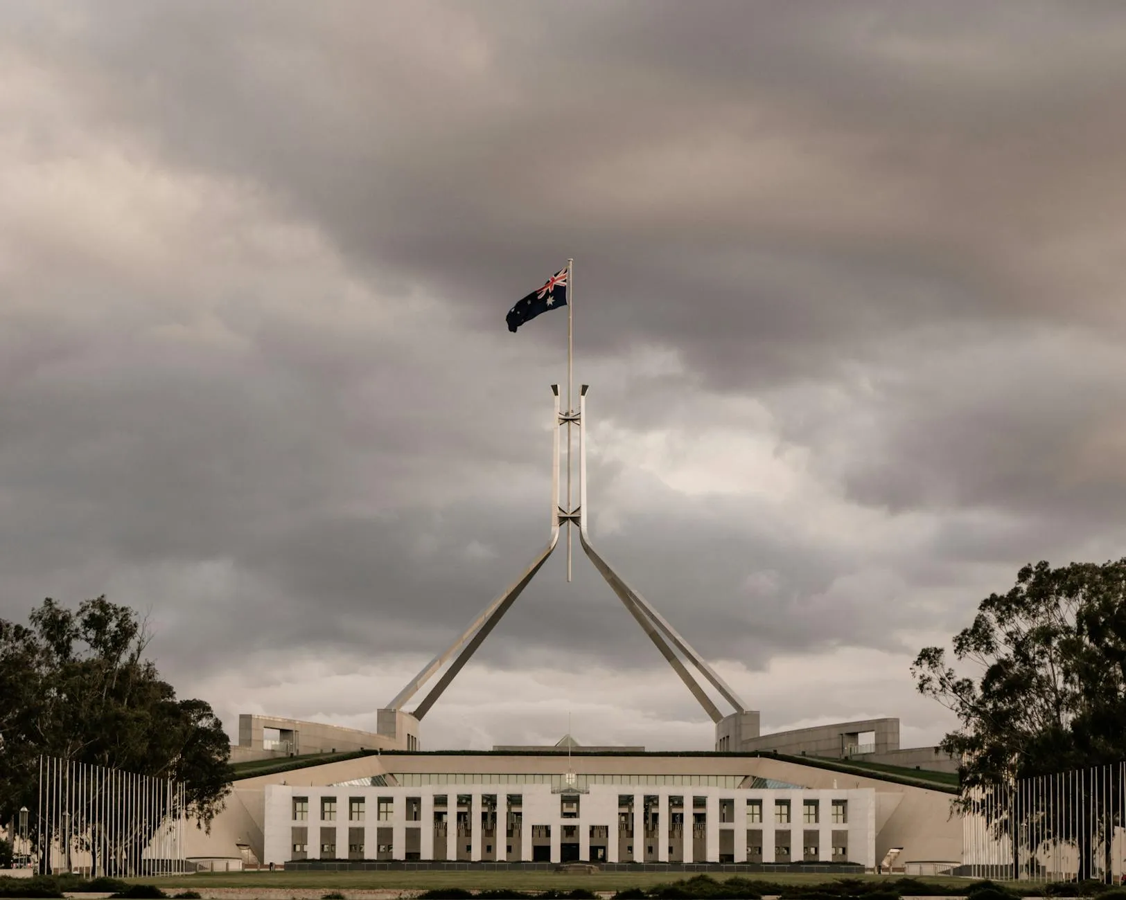 Canberra, Australia — The Parliament House of Australia in Canberra with a dramatic cloudy backdrop.