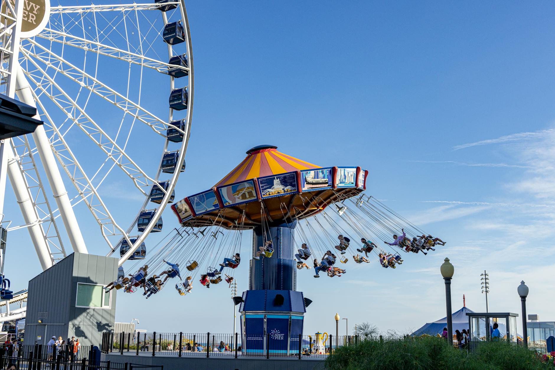 A vibrant scene of fun rides at Navy Pier in Chicago, showcasing a lively amusement park atmosphere.
