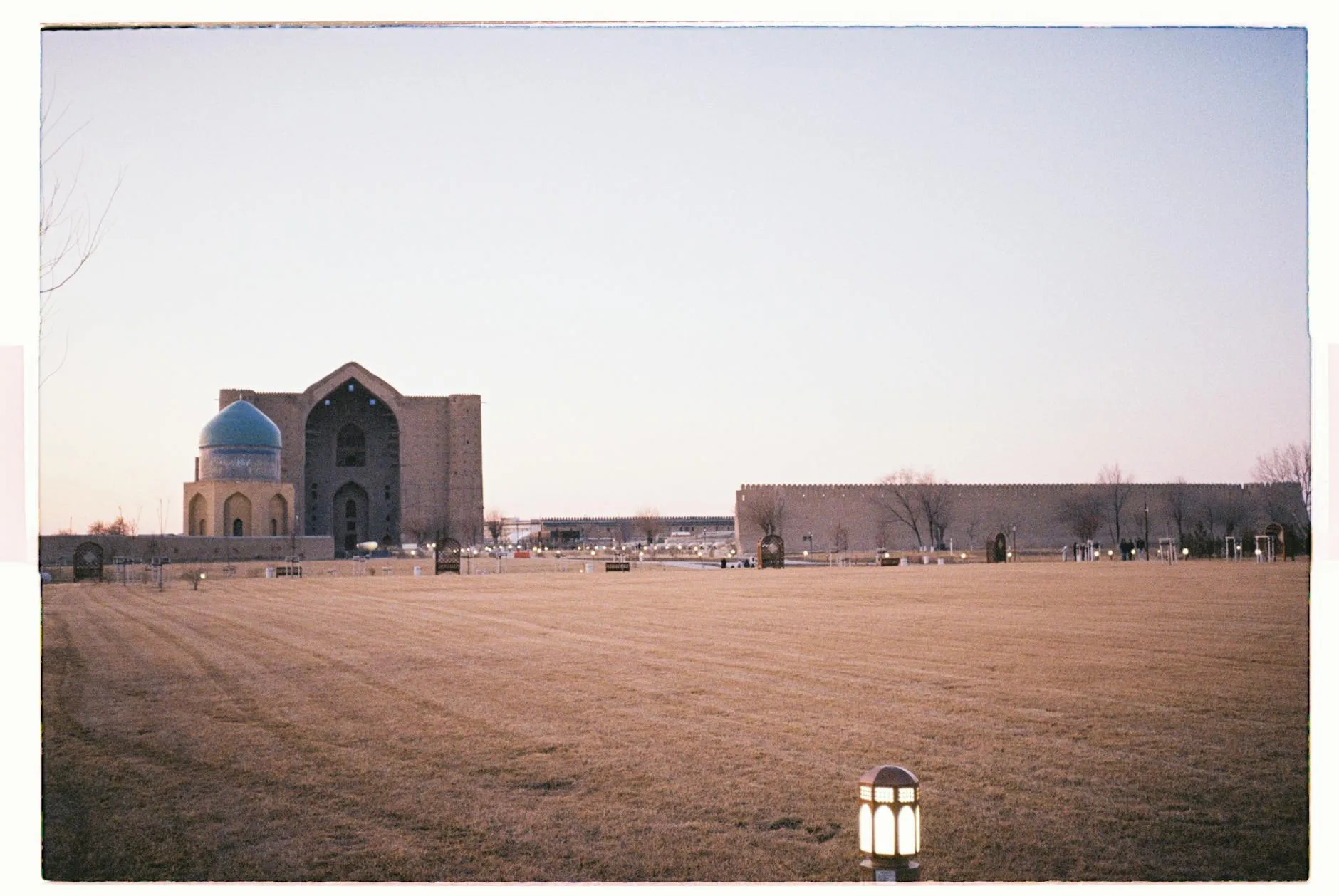 Shymkent, Kazakhstan — Mausoleum with a blue dome in Turkestan, showcasing traditional architecture at twilight.