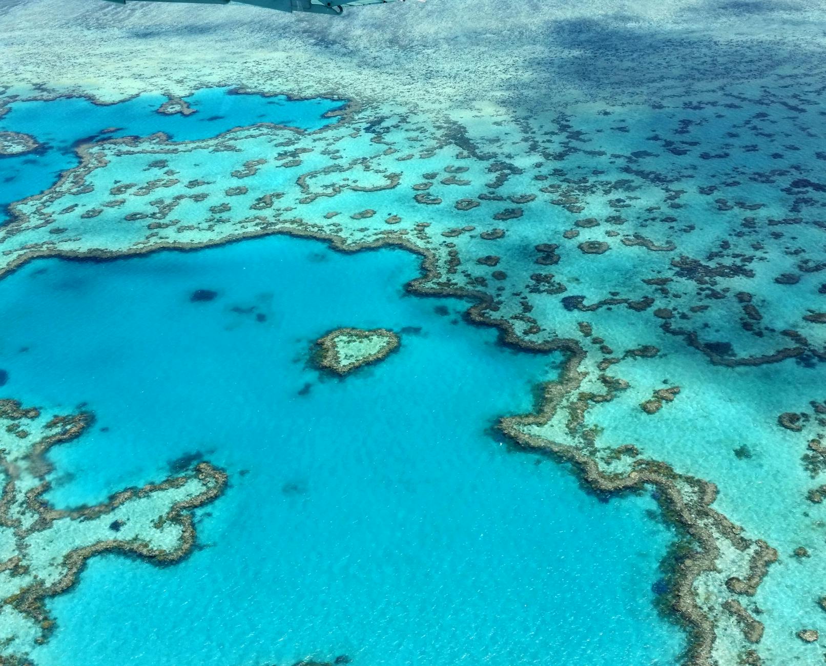 Cairns, Australia — Stunning aerial photograph of the heart-shaped Great Barrier Reef in the Whitsundays, Australia.