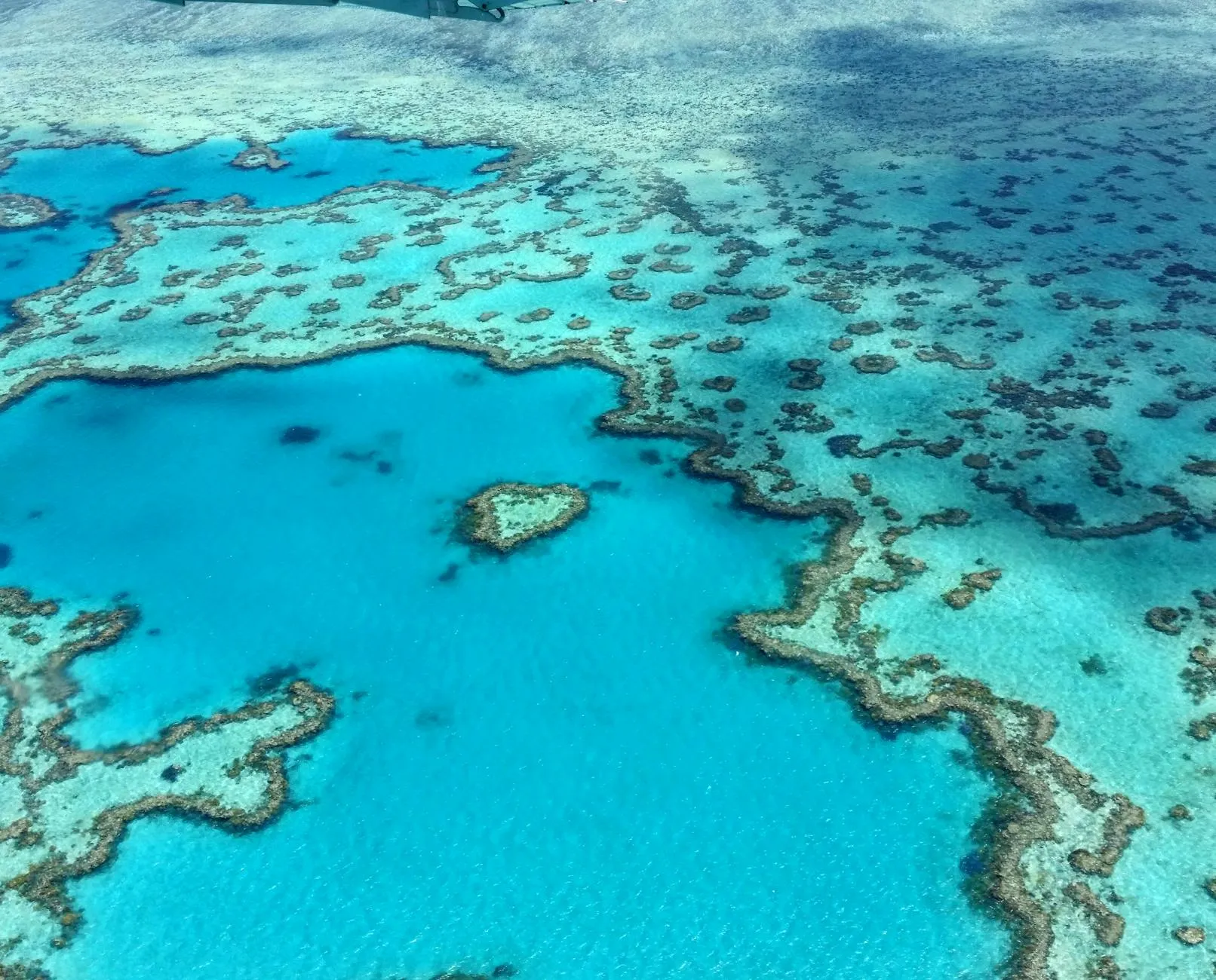 Cairns, Australia — Stunning aerial photograph of the heart-shaped Great Barrier Reef in the Whitsundays, Australia.