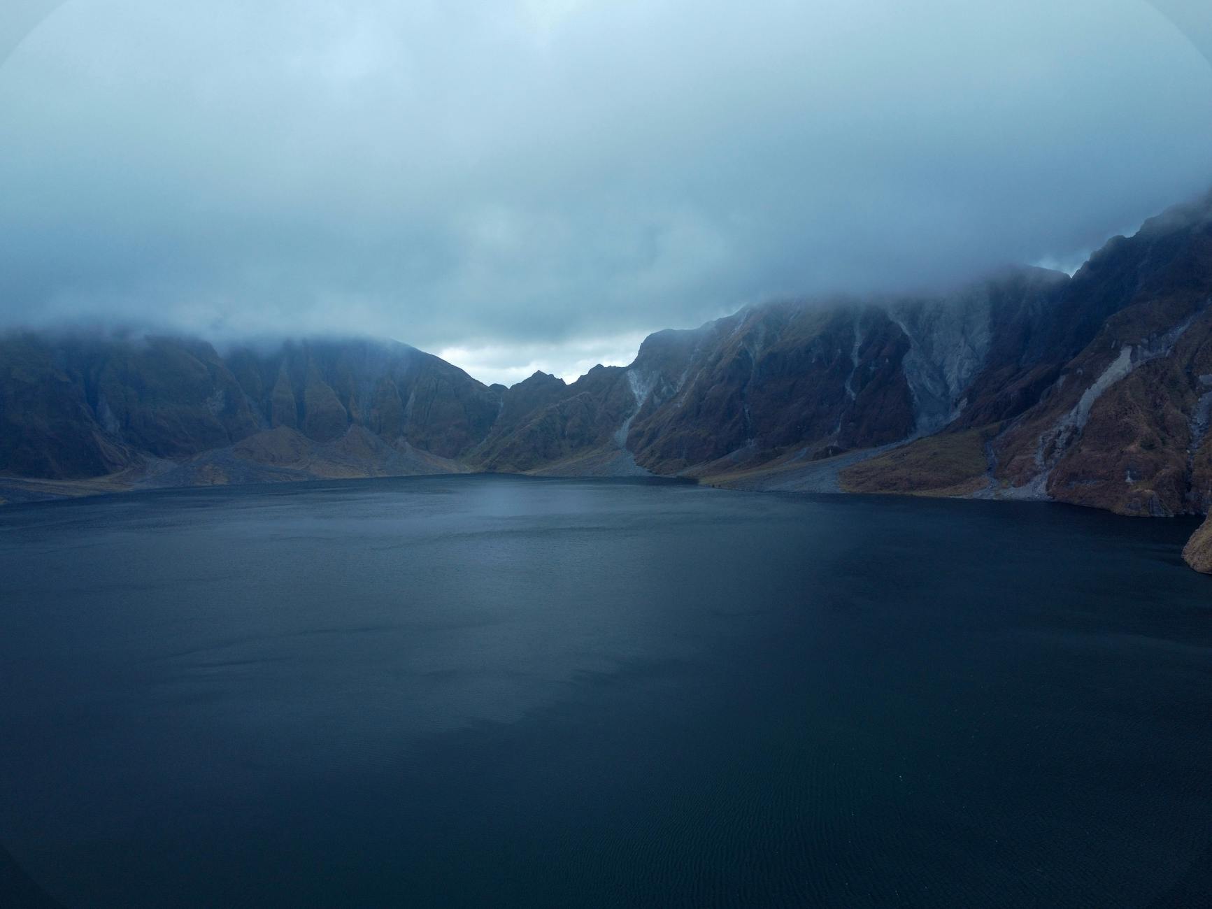 Clark, Philippines — Dramatic aerial shot of cloud-covered Mount Pinatubo's crater lake in the Philippines.