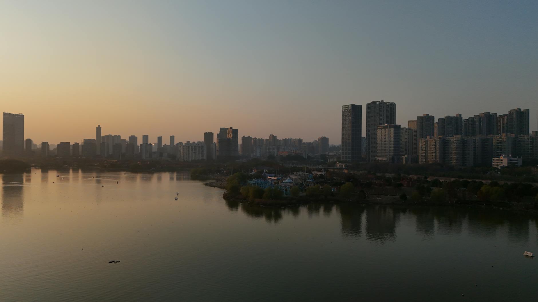 Changsha Hunan China — Scenic aerial view of Changsha city skyline with tranquil river at sunset.
