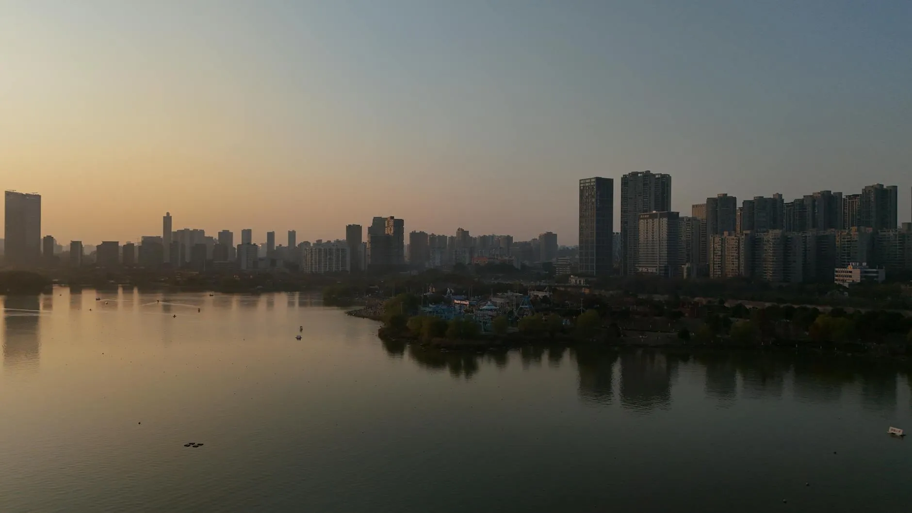 Changsha Hunan China — Scenic aerial view of Changsha city skyline with tranquil river at sunset.