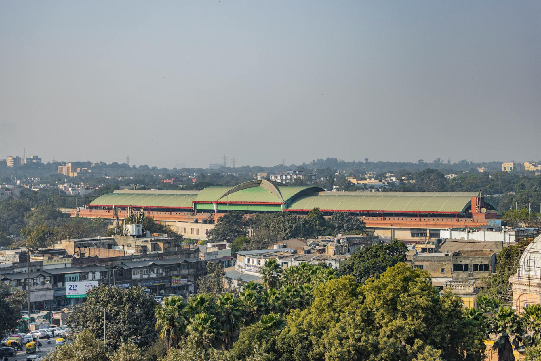 Panoramic aerial view of Pragati Maidan showcasing New Delhi's urban skyline under clear skies.