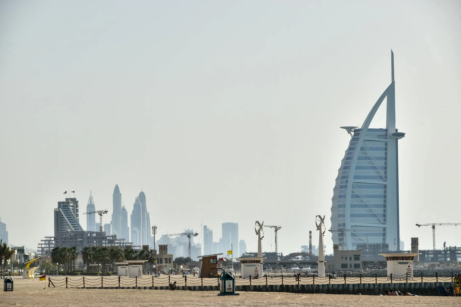 The iconic Burj Al Arab against the backdrop of Dubai's magnificent skyline, showcasing modern architecture.