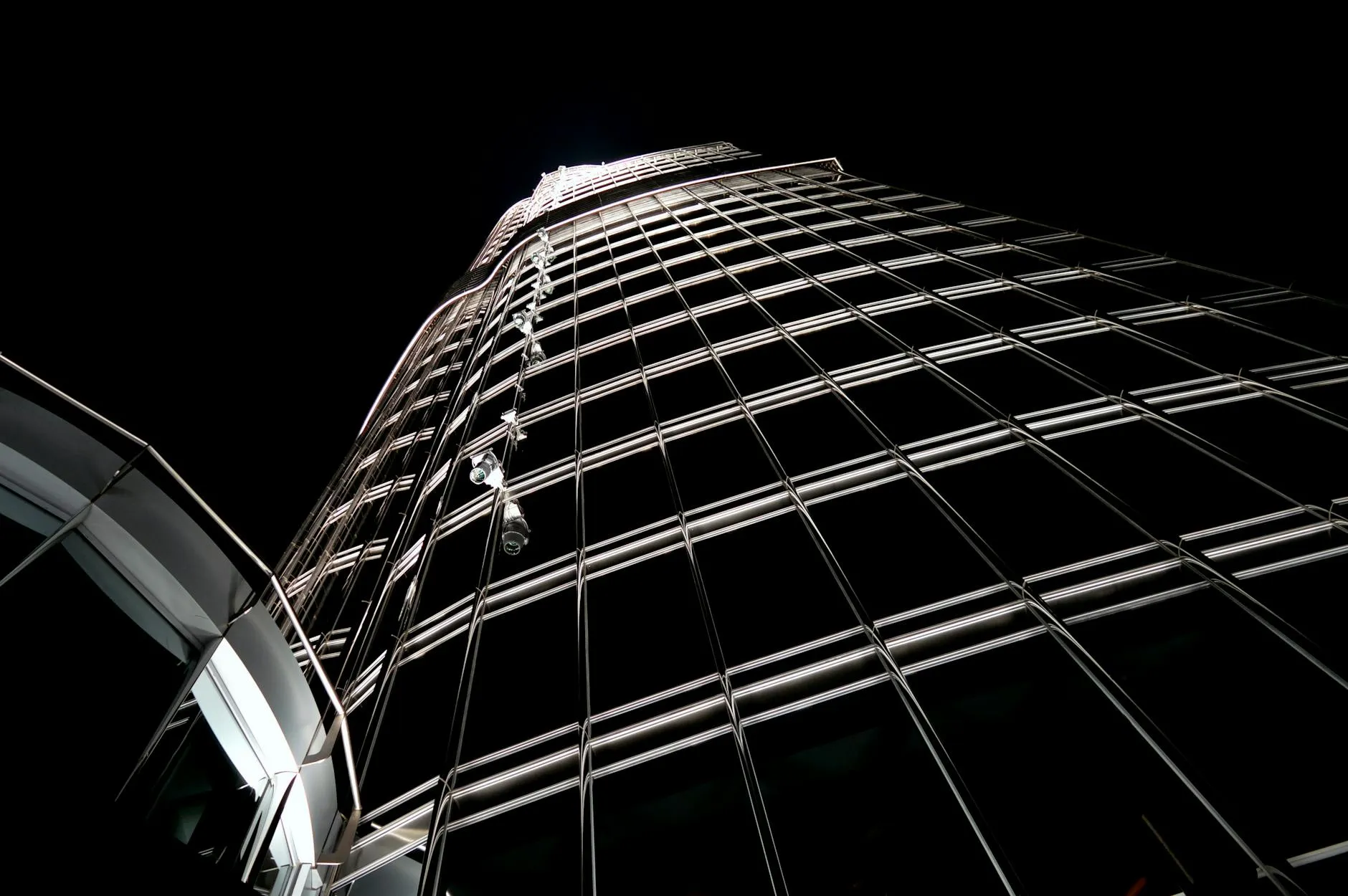 A striking upward shot of the Burj Khalifa's illuminated facade against the night sky in Dubai.