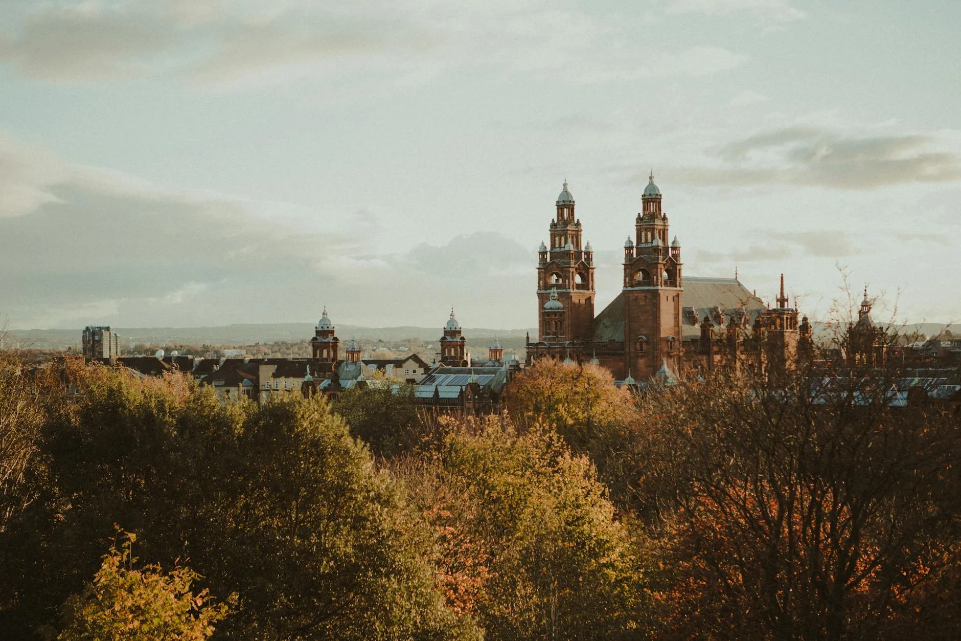 Glasgow Airport (GLA) — Scenic view of Kelvingrove Museum surrounded by autumn foliage in Glasgow, Scotland.