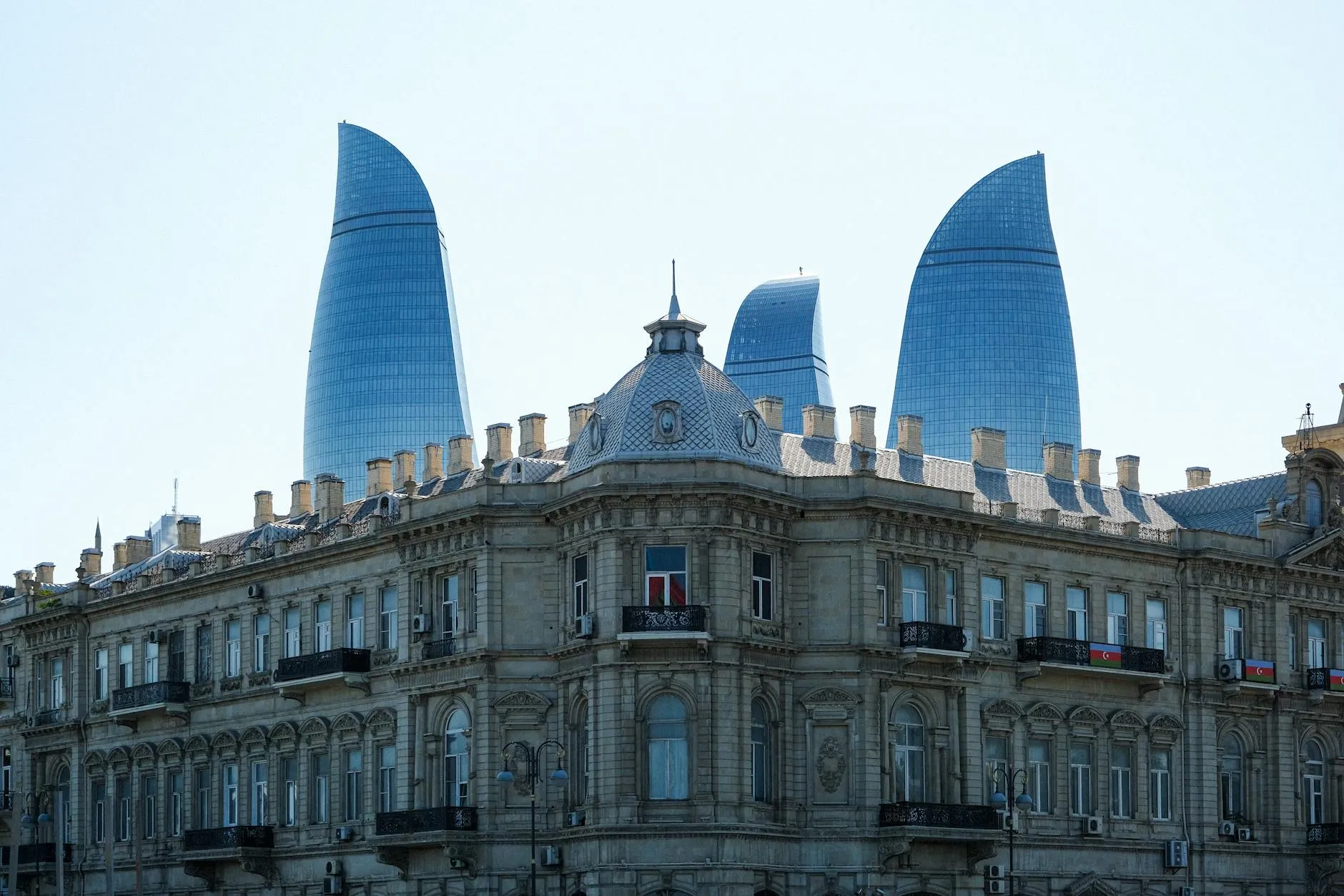 Baku Azerbaijan — Contrast between historic architecture and modern Flame Towers in Baku, Azerbaijan.