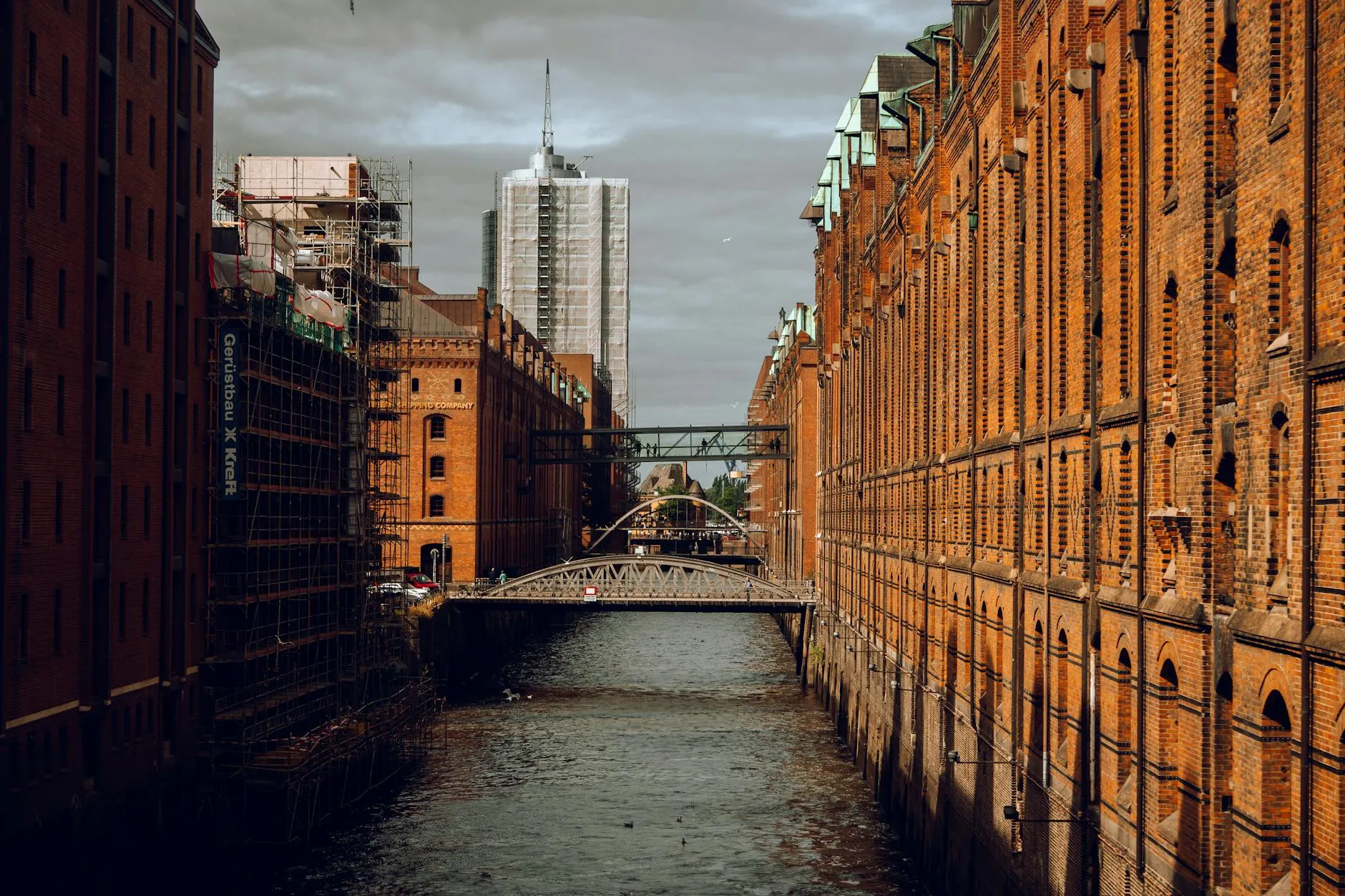 Historic red brick warehouses line the canal in Hamburg's Speicherstadt district.
