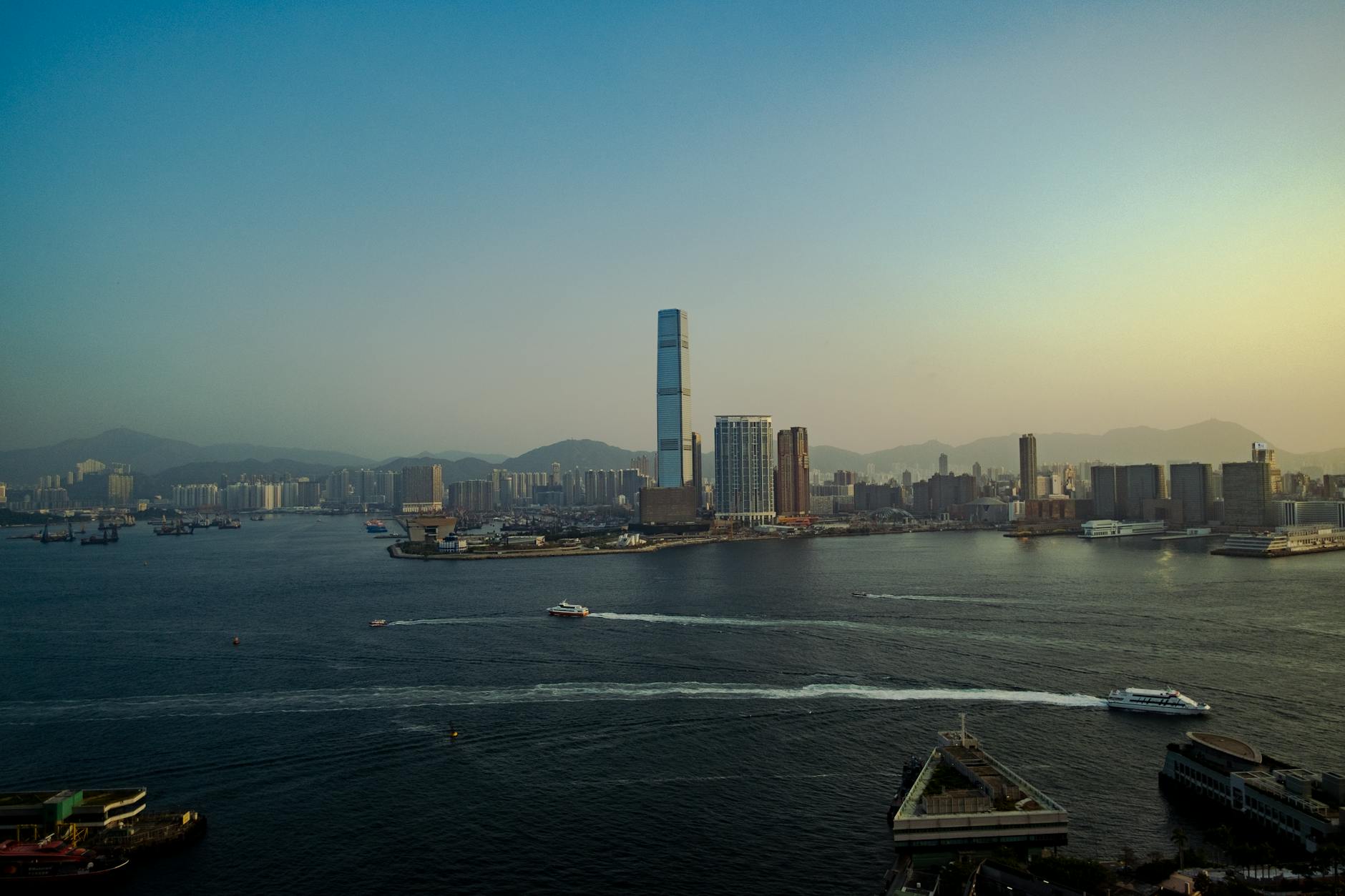 Captivating aerial view of Hong Kong's skyline with a tranquil waterfront at dusk.