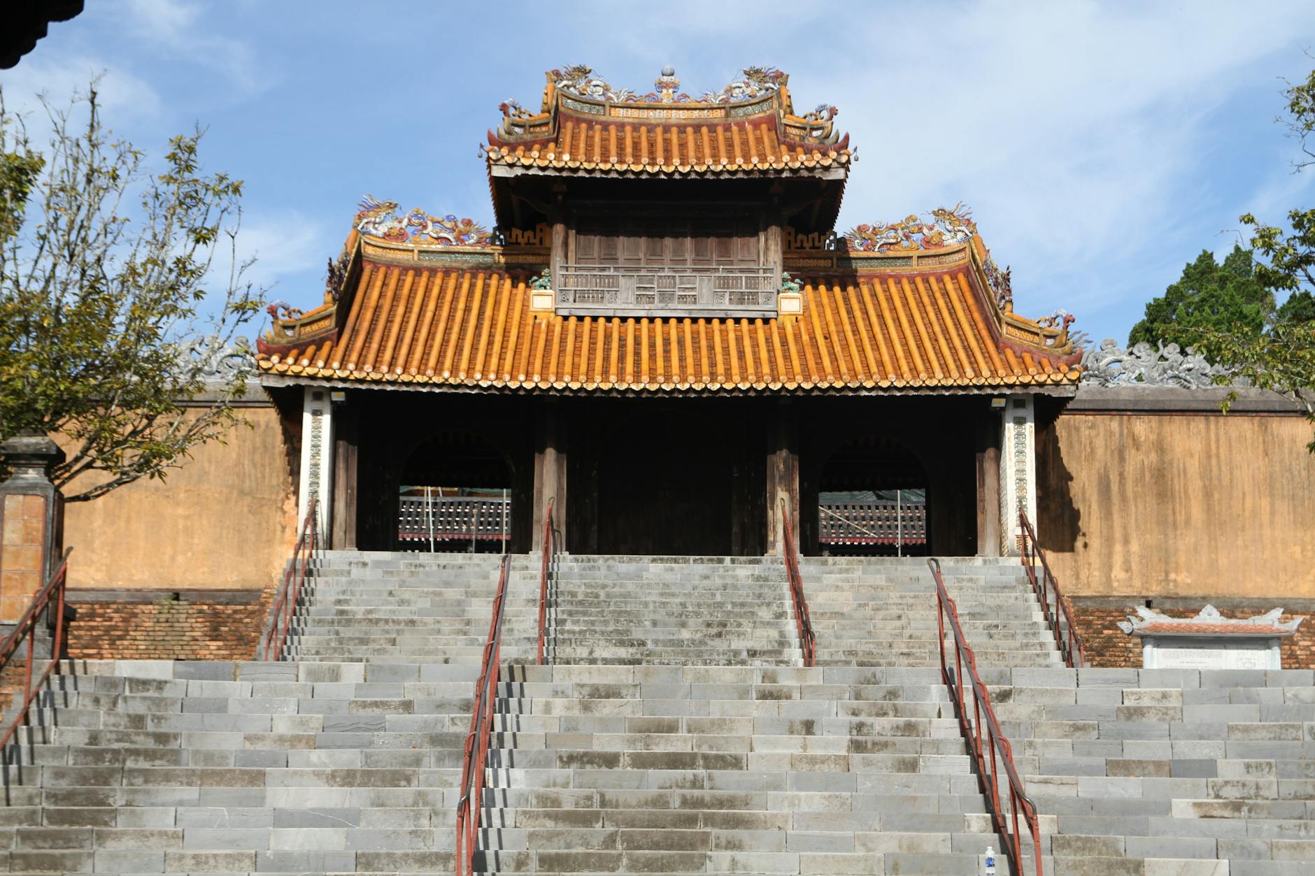Hue, Vietnam — Front view of the historic gate at the Imperial City in Hue, Vietnam with stairs leading up under a clear sky.