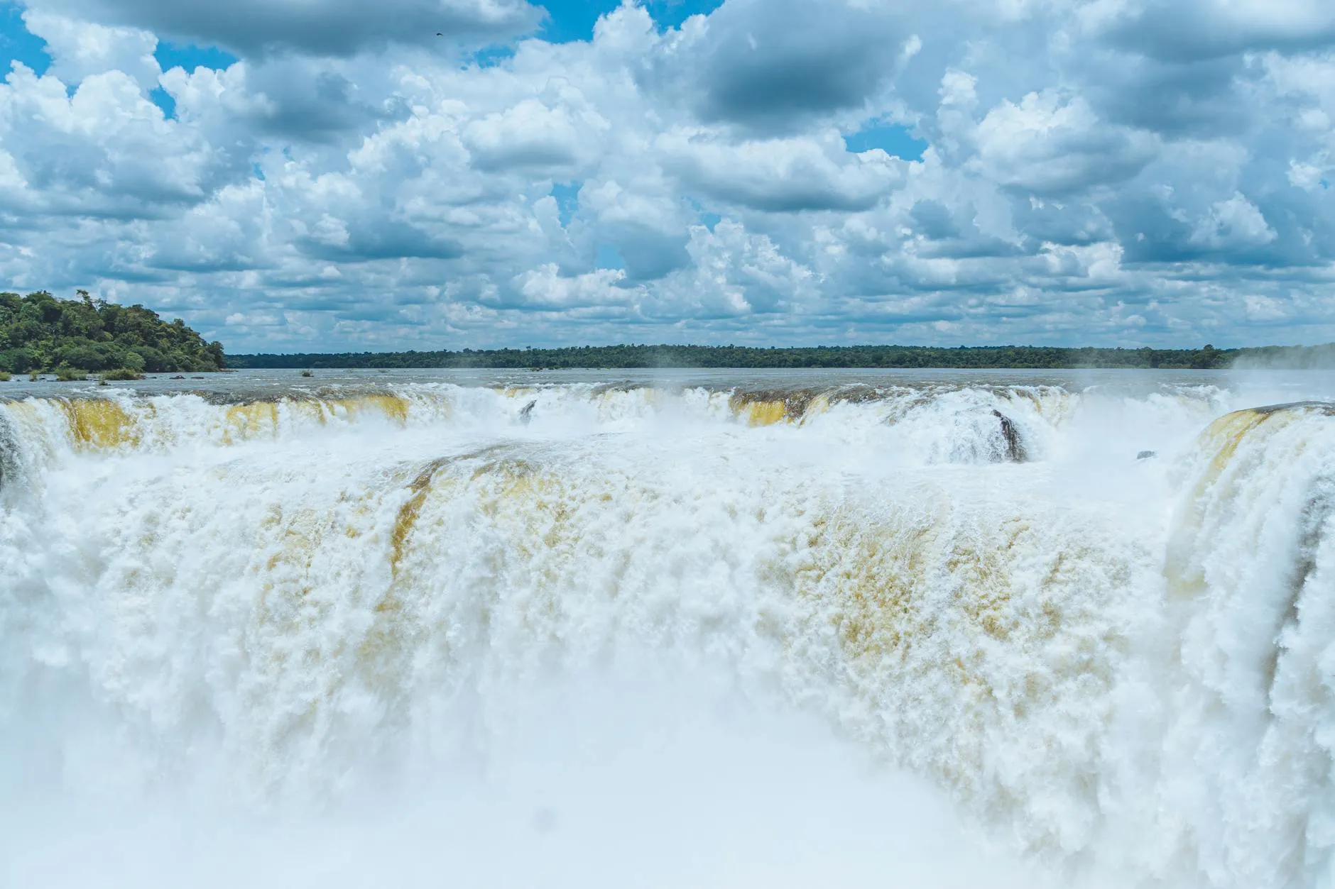 Iguazú, Argentina — Discover the breathtaking Iguazu Falls in Argentina under a vibrant sky.