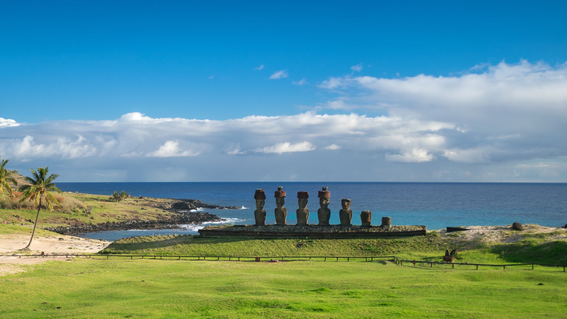 Easter Island (Rapa Nui), Chile — Iconic Moai statues at Ahu Tongariki under a clear blue sky on Easter Island's coast.
