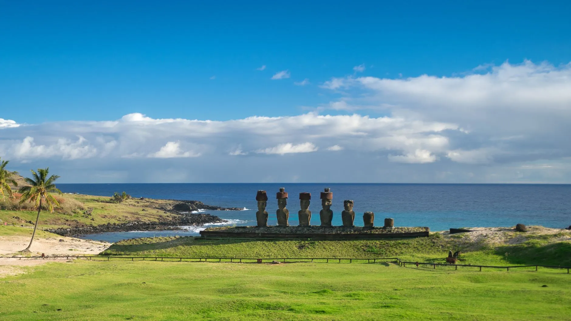 Easter Island (Rapa Nui), Chile — Iconic Moai statues at Ahu Tongariki under a clear blue sky on Easter Island's coast.