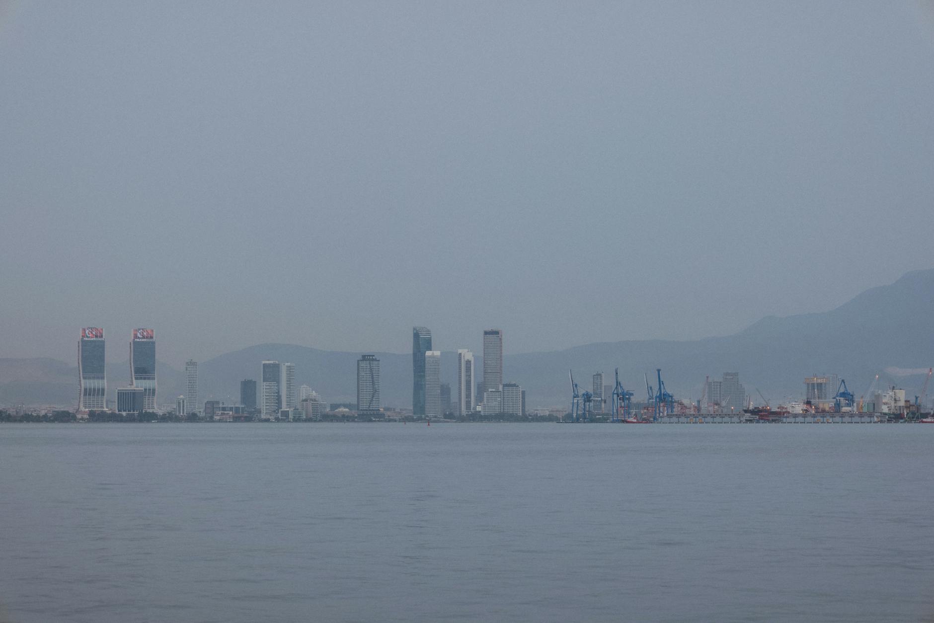 Cityscape of Izmir showcasing waterfront skyline with modern skyscrapers.