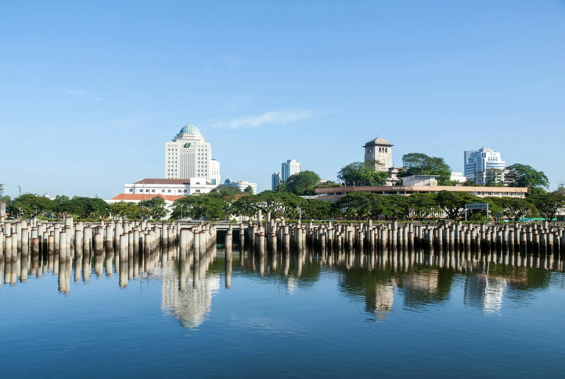 Johor Bahru, Malaysia — Beautiful view of Johor Bahru skyline reflecting on calm water on a sunny day.