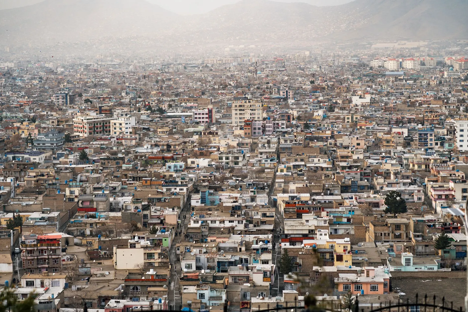 Kabul, Afghanistan — Expansive aerial view of Kabul city, showcasing urban density and surrounding mountains in Afghanistan.