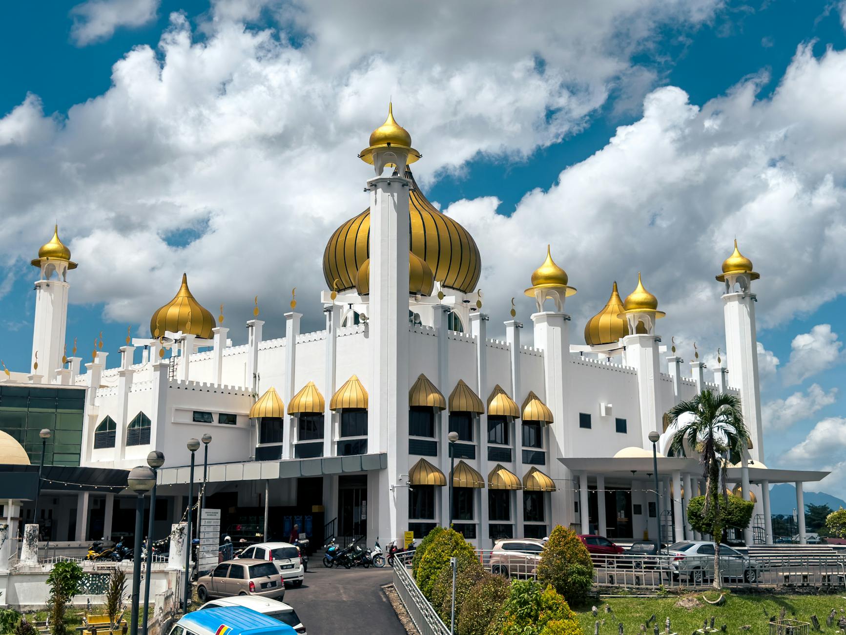 Kuching, Sarawak, Malaysia — Majestic mosque with golden domes in Kuching, Sarawak, showcasing Islamic architecture.