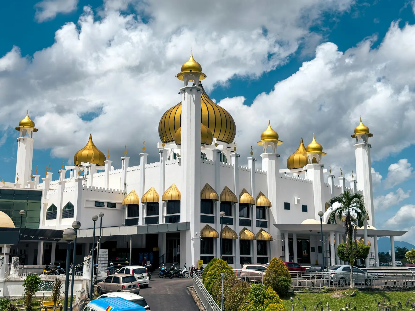 Kuching, Sarawak, Malaysia — Majestic mosque with golden domes in Kuching, Sarawak, showcasing Islamic architecture.