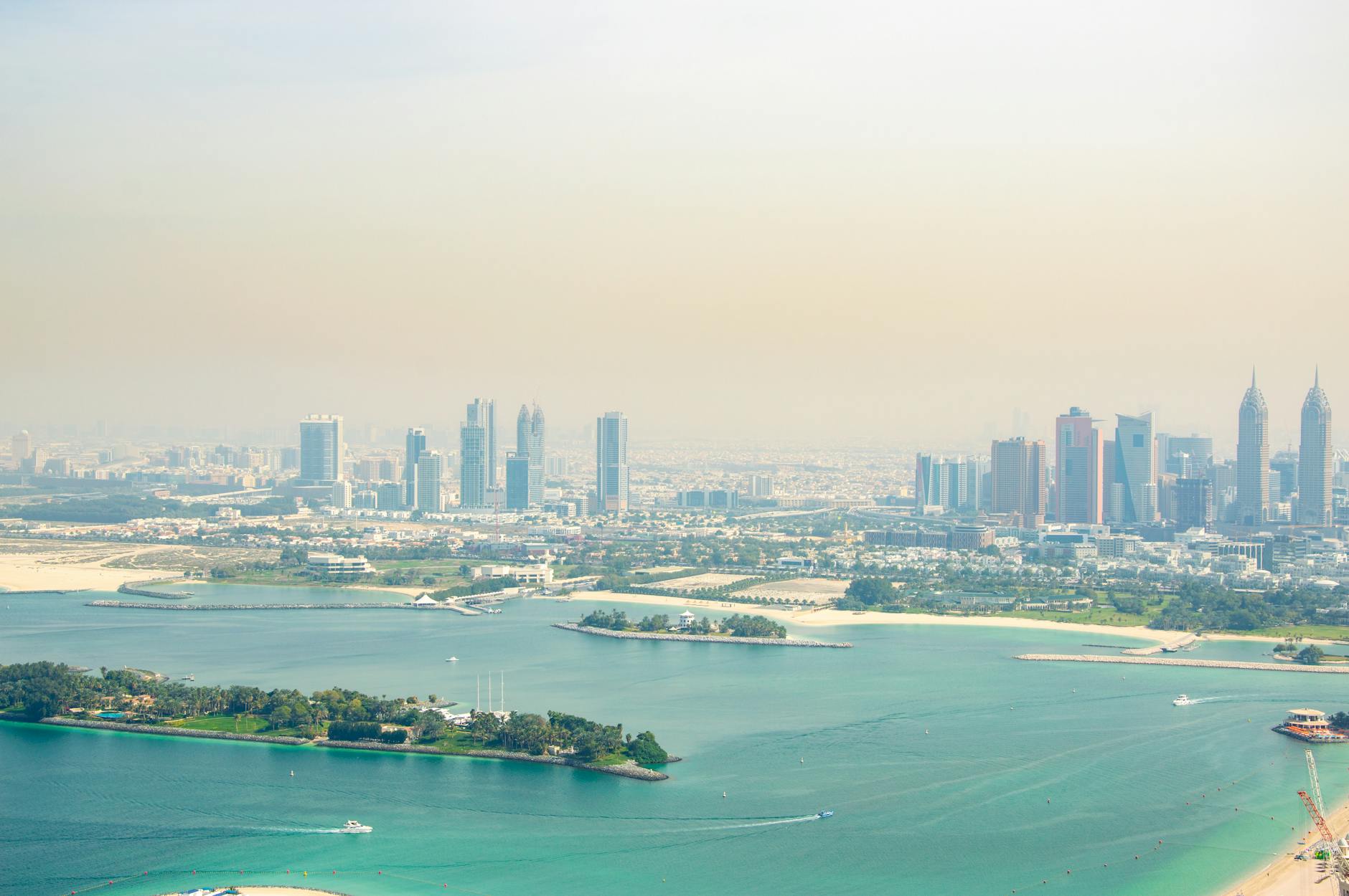 Stunning aerial view of Dubai's skyline with pristine coastline and turquoise waters.