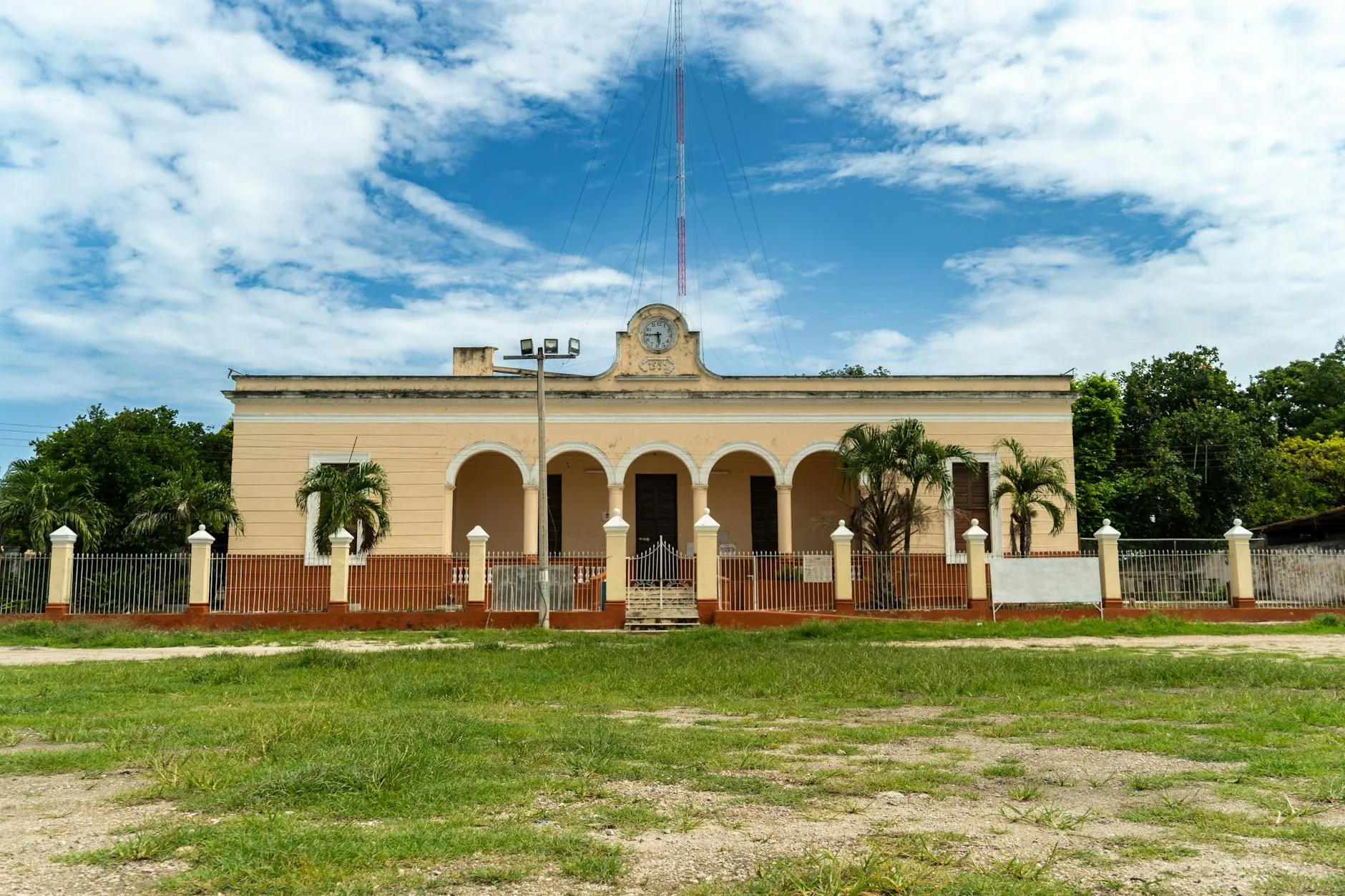 Historic colonial building in Suma, Yucatán under a vibrant blue sky.