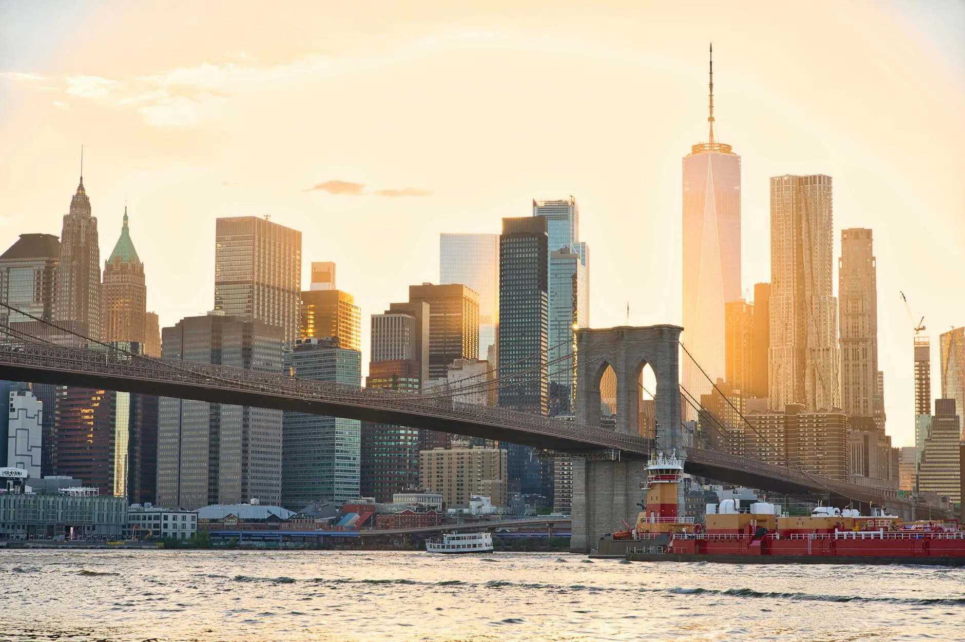 A stunning view of the Brooklyn Bridge and New York City's skyline at sunset.