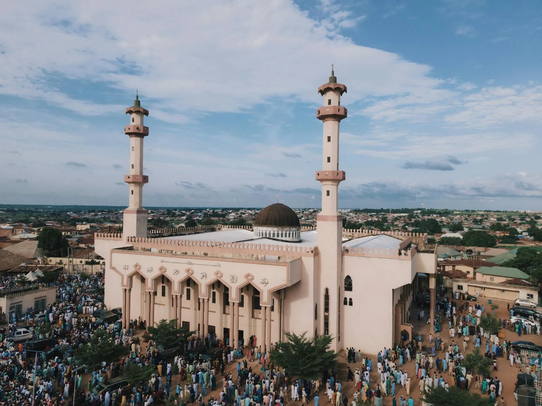 Stunning aerial photograph of a bustling mosque in Nigeria, capturing vibrant community life.