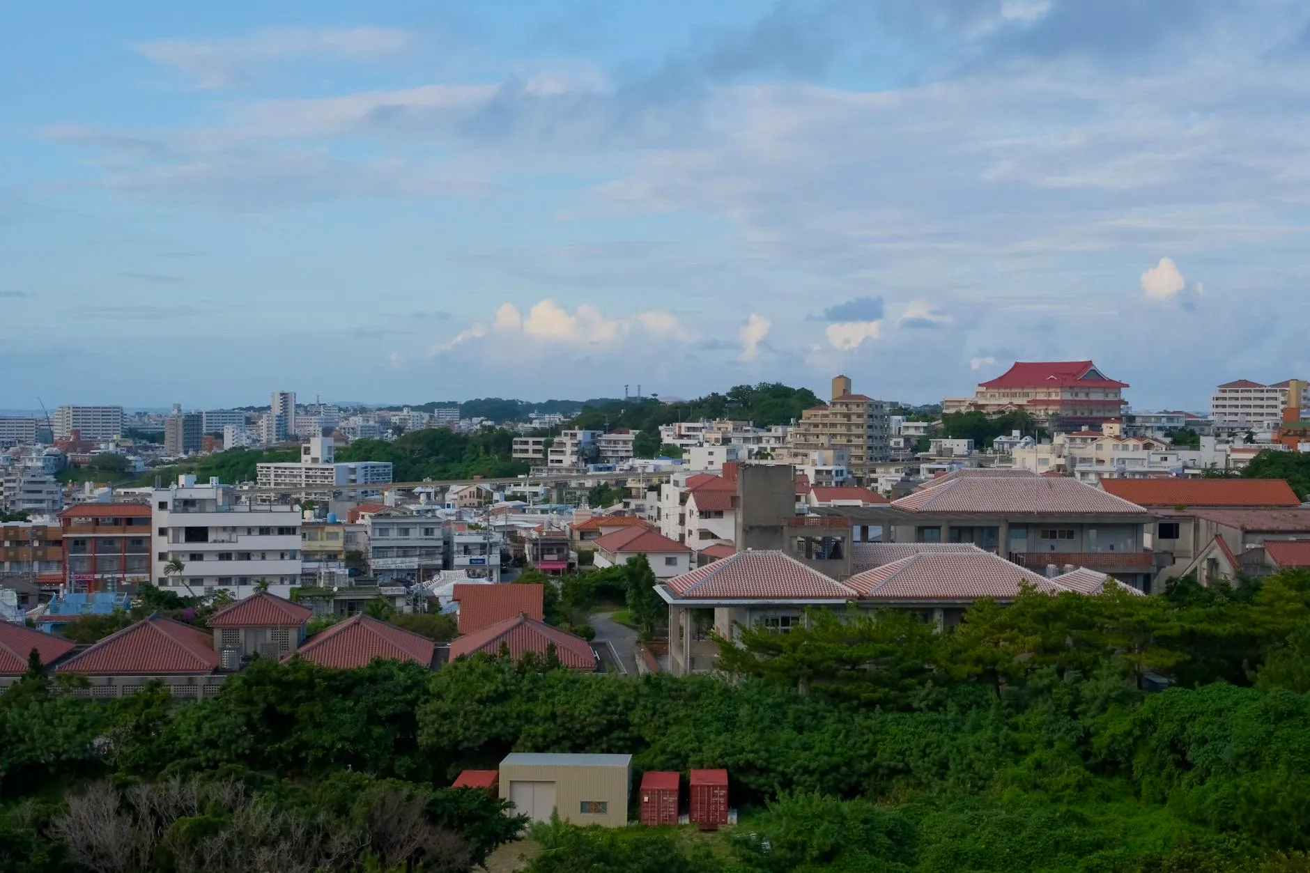 Panoramic view of Okinawa cityscape with traditional and modern buildings.