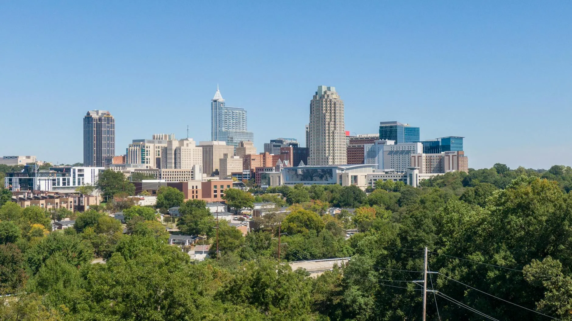 Raleigh-Durham International Airport (RDU) — A clear view of Raleigh's skyline, showcasing modern skyscrapers and urban greenery.