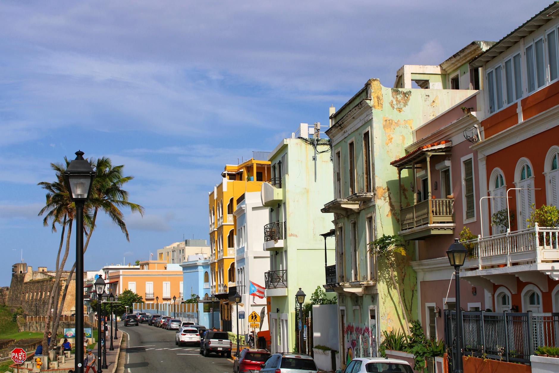 Vibrant colonial buildings line a sunny street in Old San Juan, Puerto Rico's historic district.