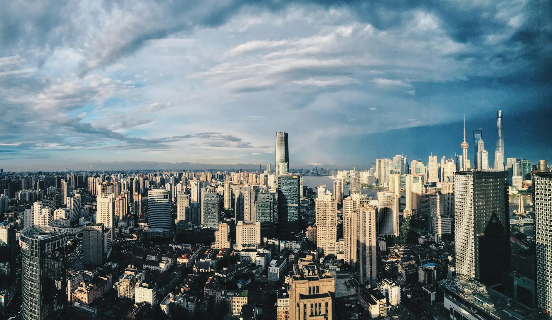 A breathtaking panoramic view of Shanghai's modern skyline under a dramatic sky.