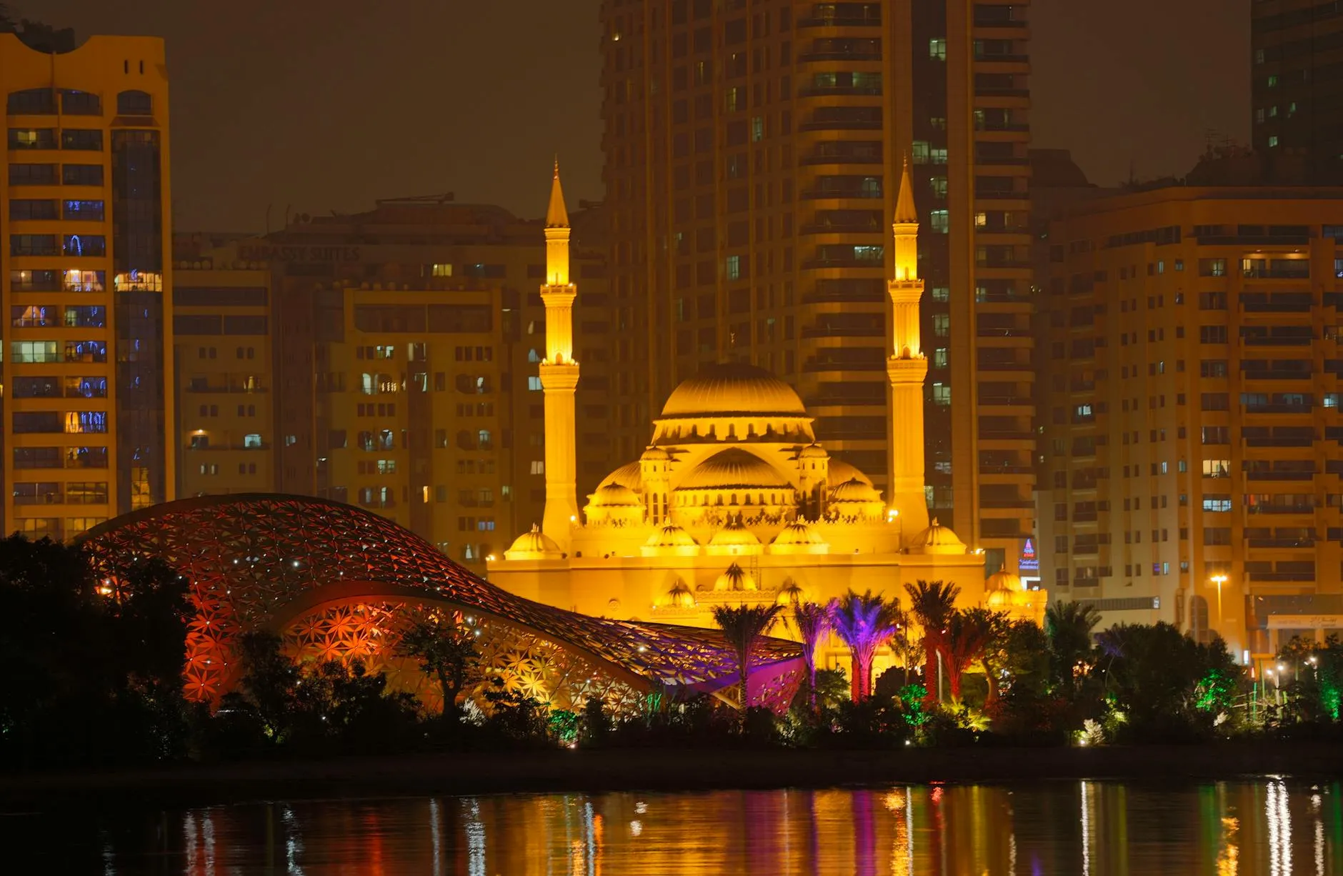 Sharjah, UAE — Stunning night view of the Al Noor Mosque with vibrant city backdrop in Sharjah, UAE.