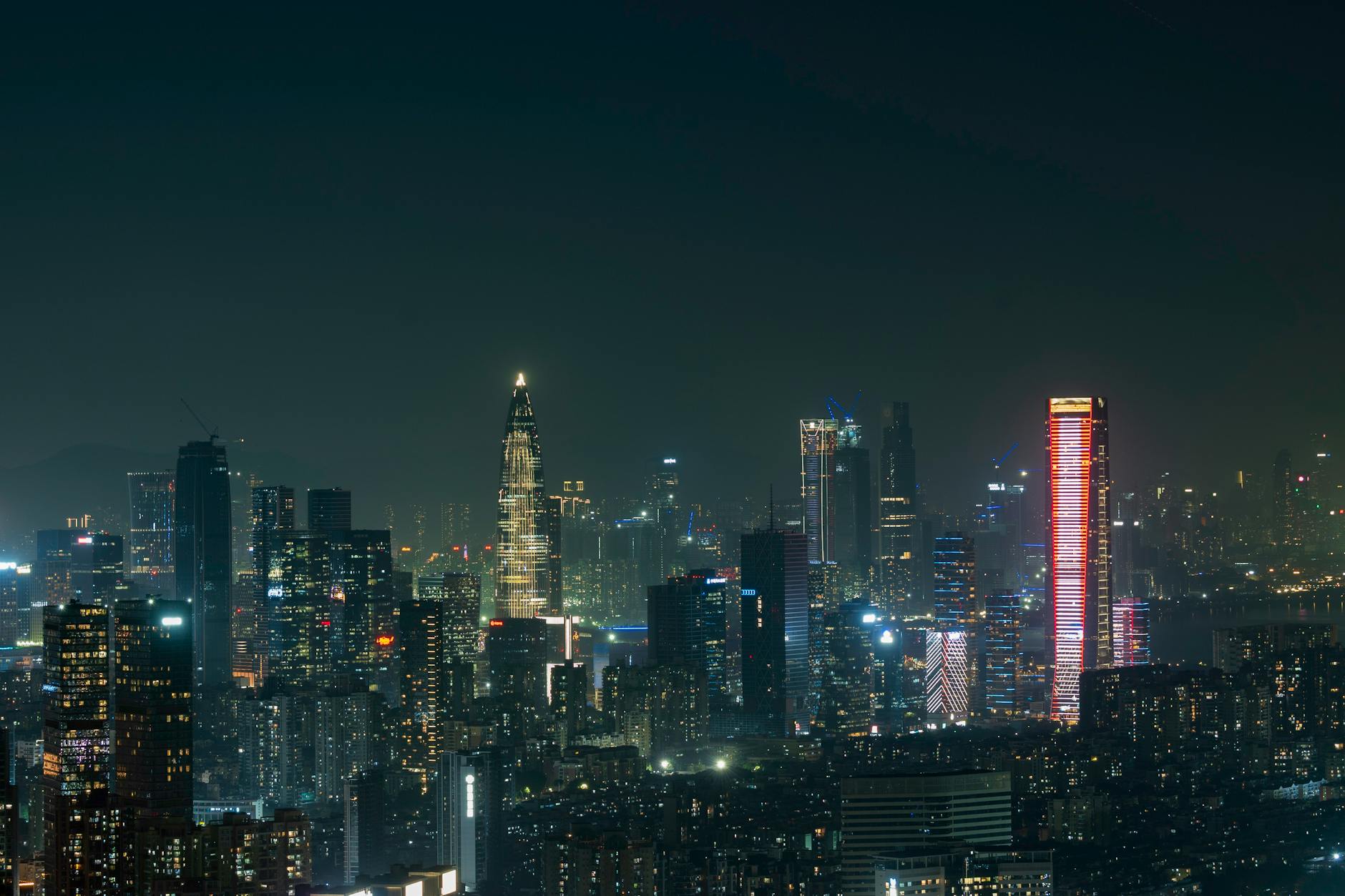 Shenzhen Bao'an International Airport (SZX) — Explore the vibrant skyline of Shenzhen at night, showcasing illuminated skyscrapers and a bustling cityscape.