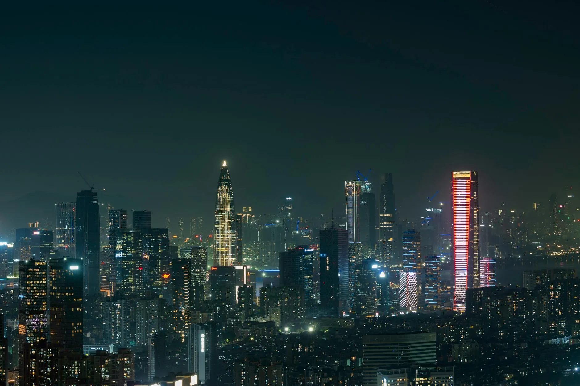 Shenzhen Bao'an International Airport (SZX) — Explore the vibrant skyline of Shenzhen at night, showcasing illuminated skyscrapers and a bustling cityscape.
