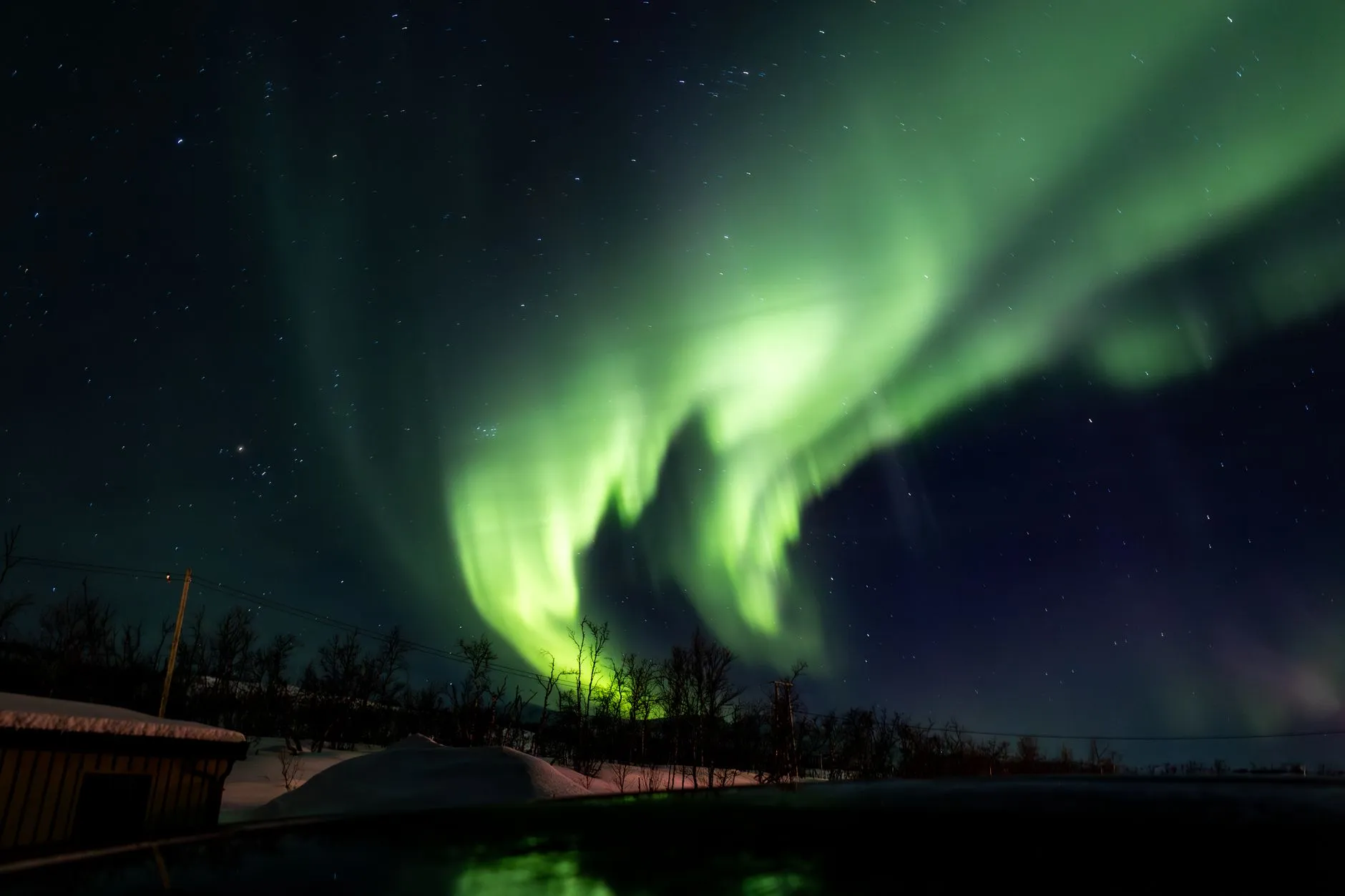 Tromsø Norway — Captivating Northern Lights illuminating a snowy winter landscape in Tromsø, Norway.