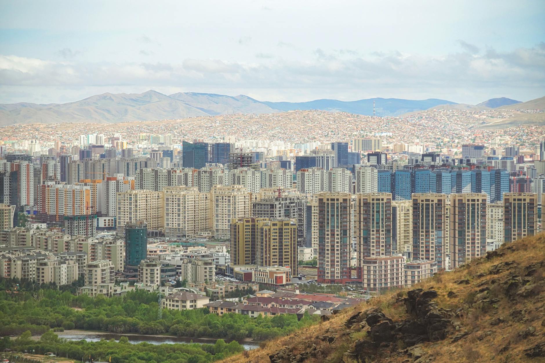 Explore the urban skyline of Ulaanbaatar, Mongolia with mountains in the backdrop.