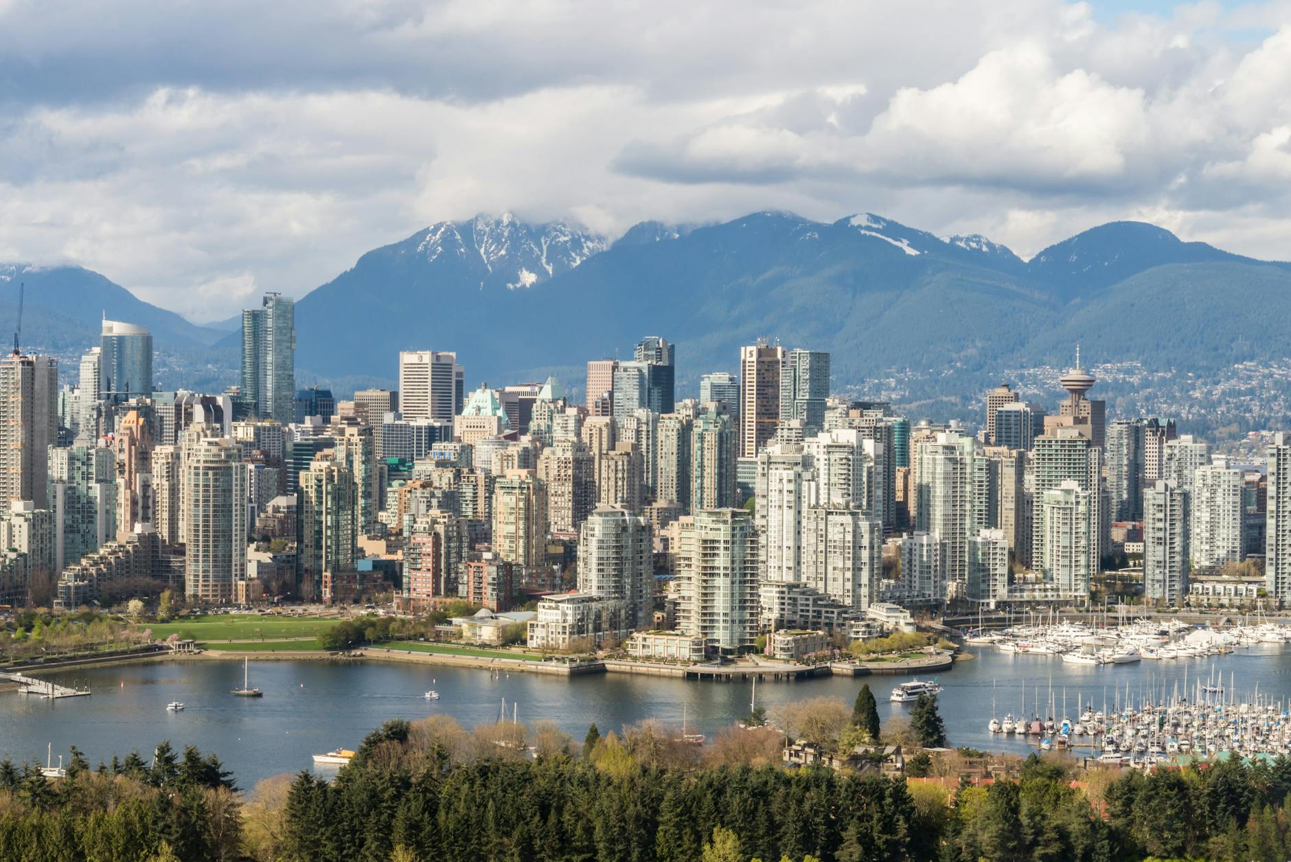 Stunning view of Vancouver's skyline with mountains and marina in the background.