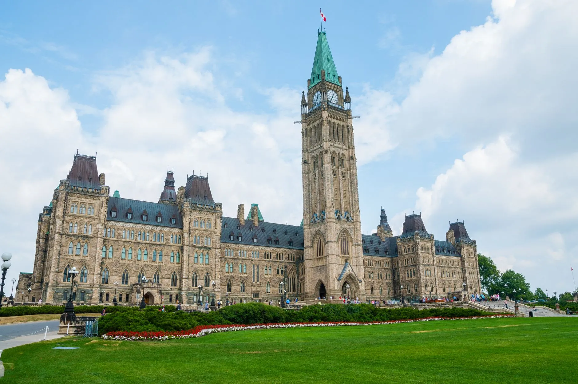 Ottawa Macdonald-Cartier Airport (YOW) — Stunning photo of Canada's Parliament Hill in Ottawa under a clear sky, showcasing Gothic Revival architecture.