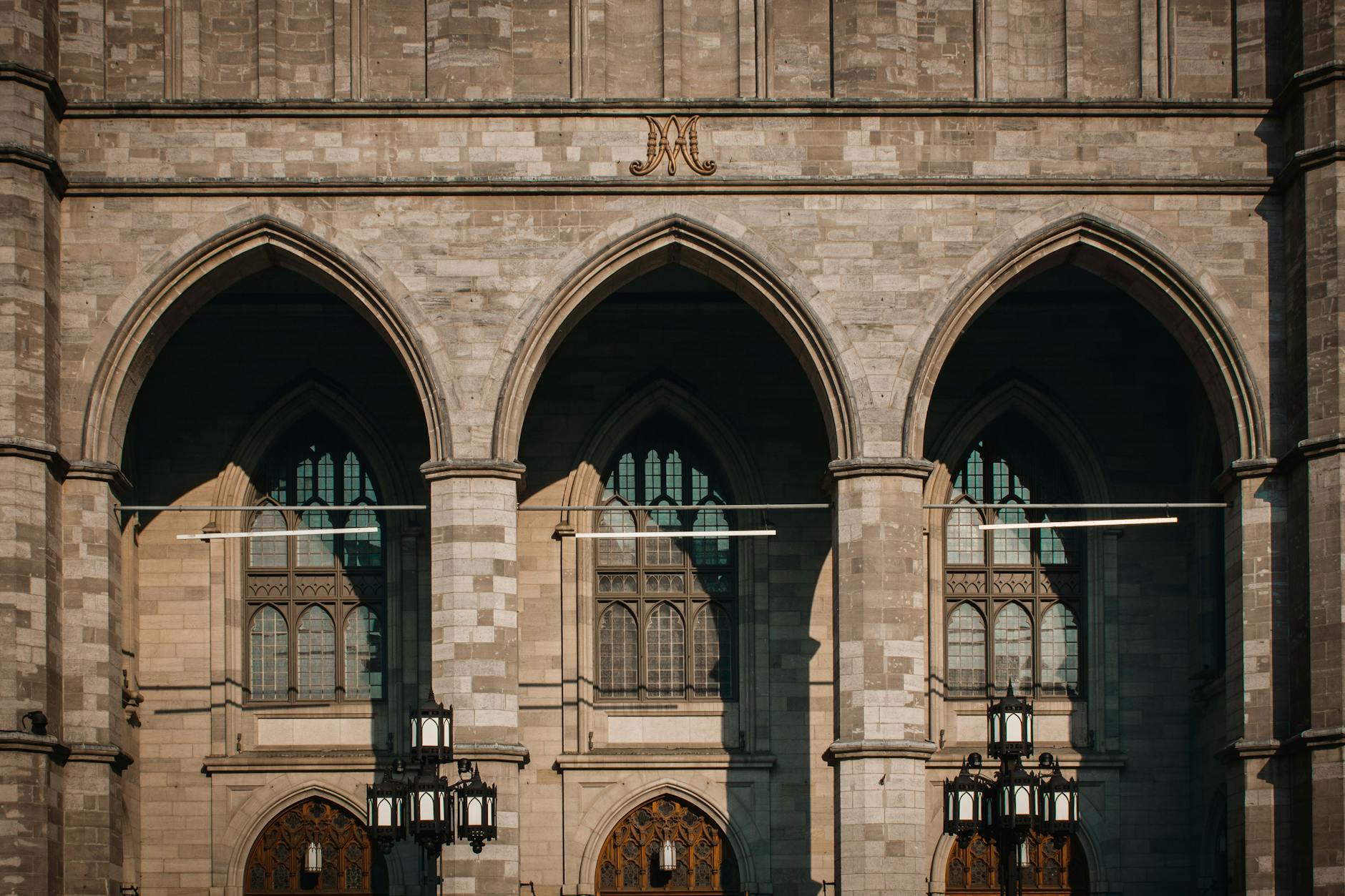 Montréal-Trudeau Airport (YUL) — Facade of the Gothic Revival Notre-Dame Basilica in Montreal, showcasing elegant arches and intricate design.
