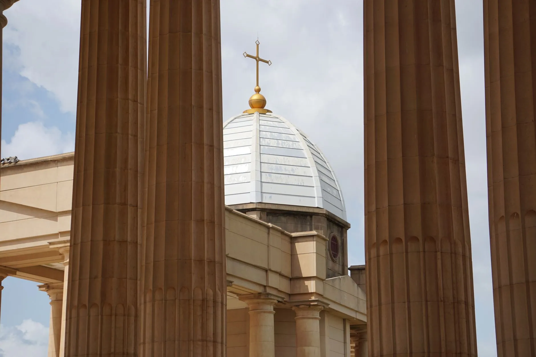 Côte d'Ivoire — Low angle view of the Basilica of Our Lady of Peace dome framed by columns in Yamoussoukro, Côte d'Ivoire.