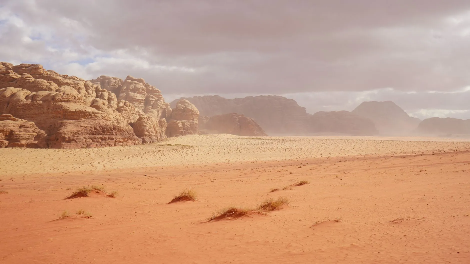 Jordan — Explore the breathtaking red desert landscape of Wadi Rum, Jordan with towering sandstone formations.