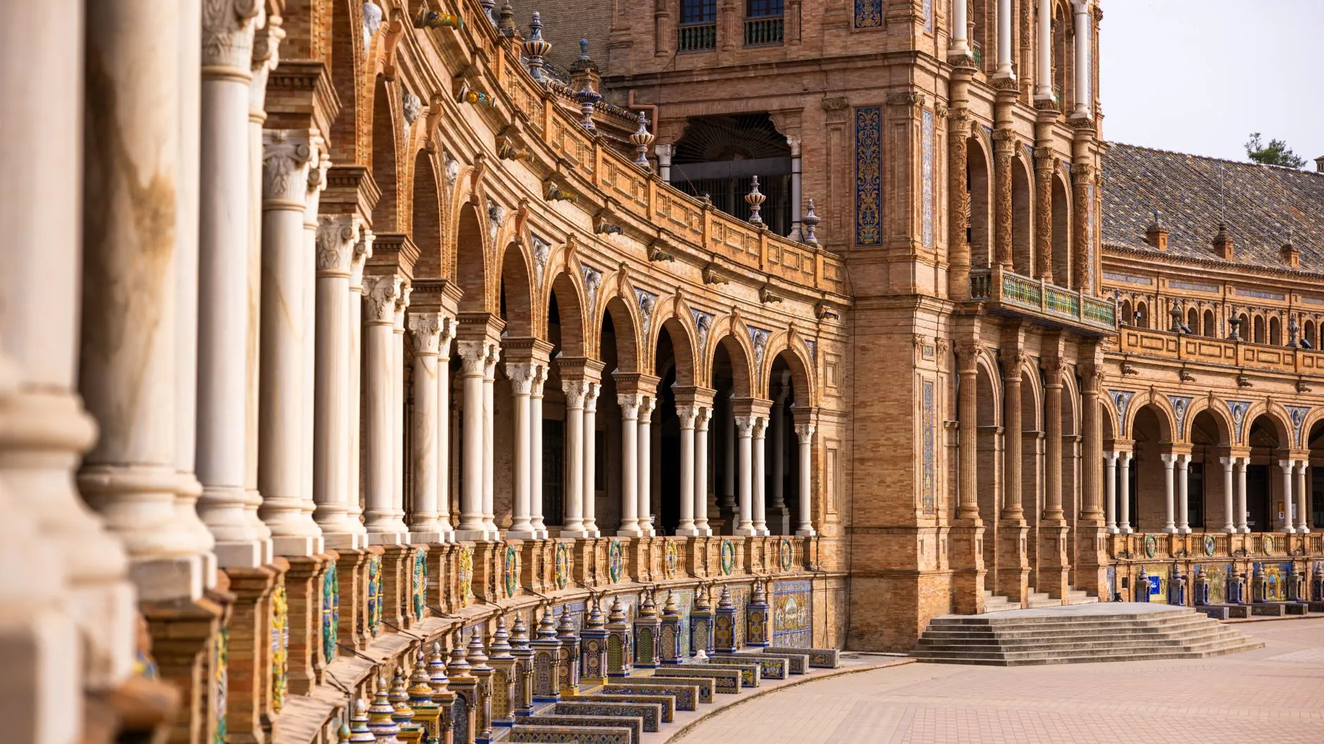 Spain — Elegant arches and ornate architecture of Plaza de España in Seville, Spain, showcasing historical grandeur.