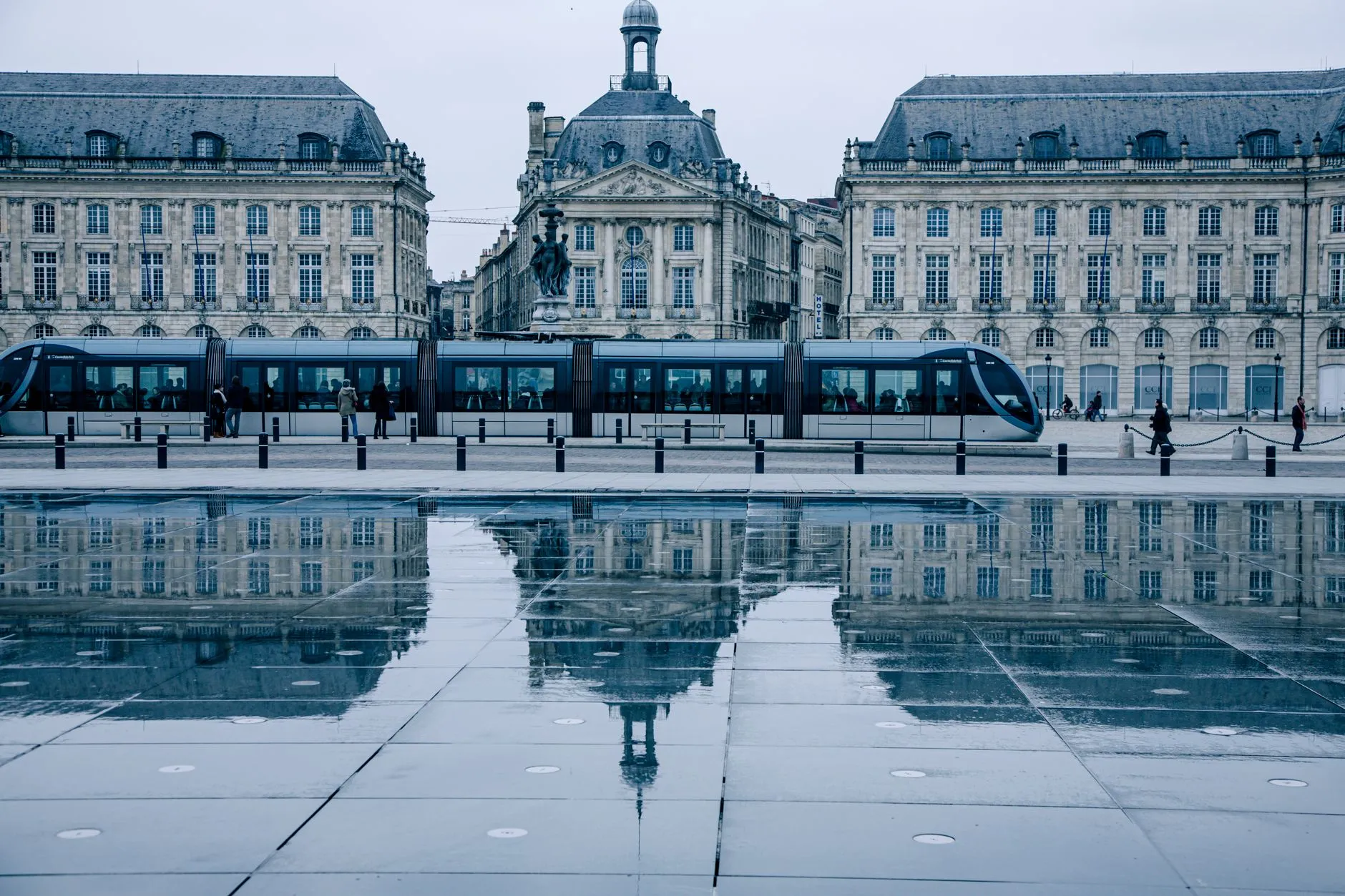 Bordeaux, France — Tram passing by the historic Place de la Bourse in Bordeaux, reflecting on the Miroir d'eau.