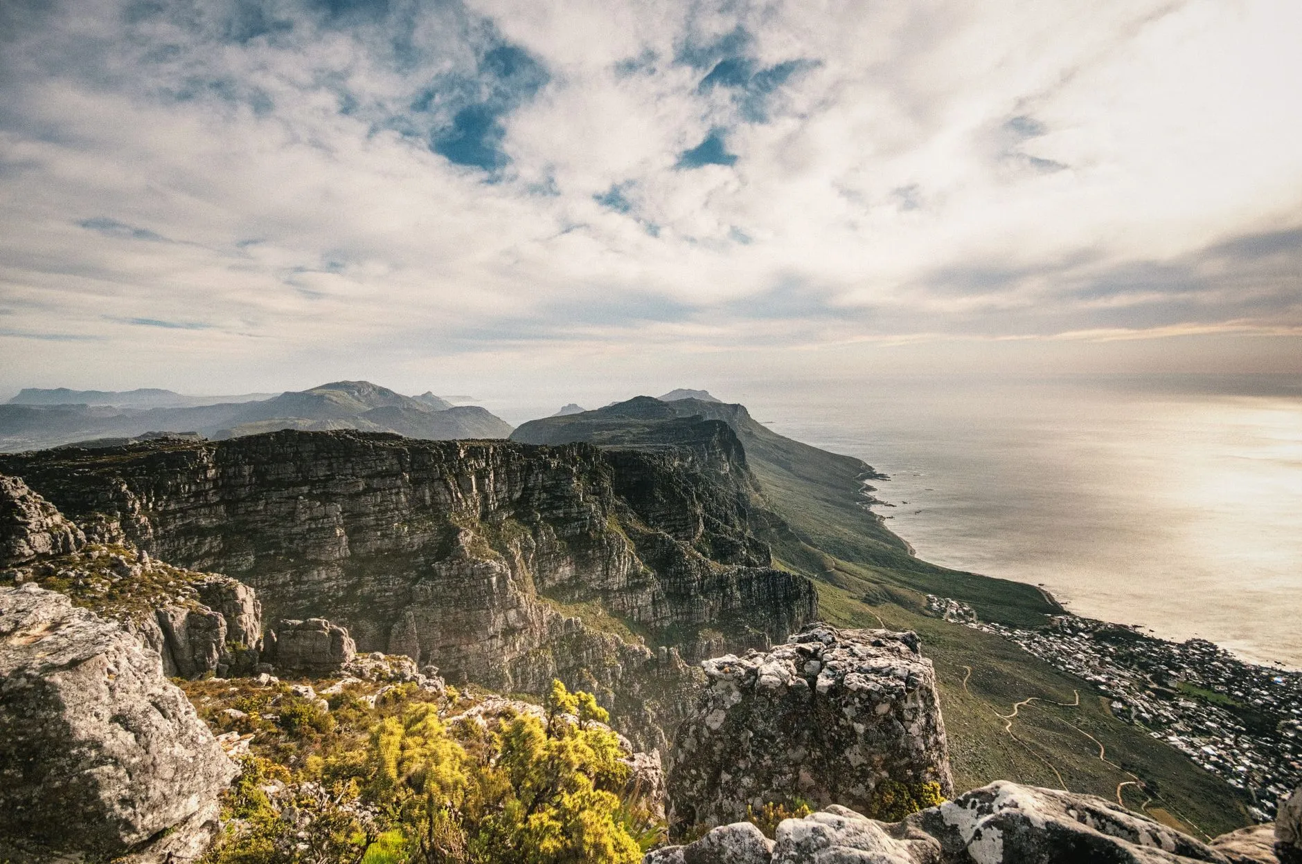 South Africa — Breathtaking aerial view from Table Mountain, South Africa, highlighting rugged cliffs and vast ocean.
