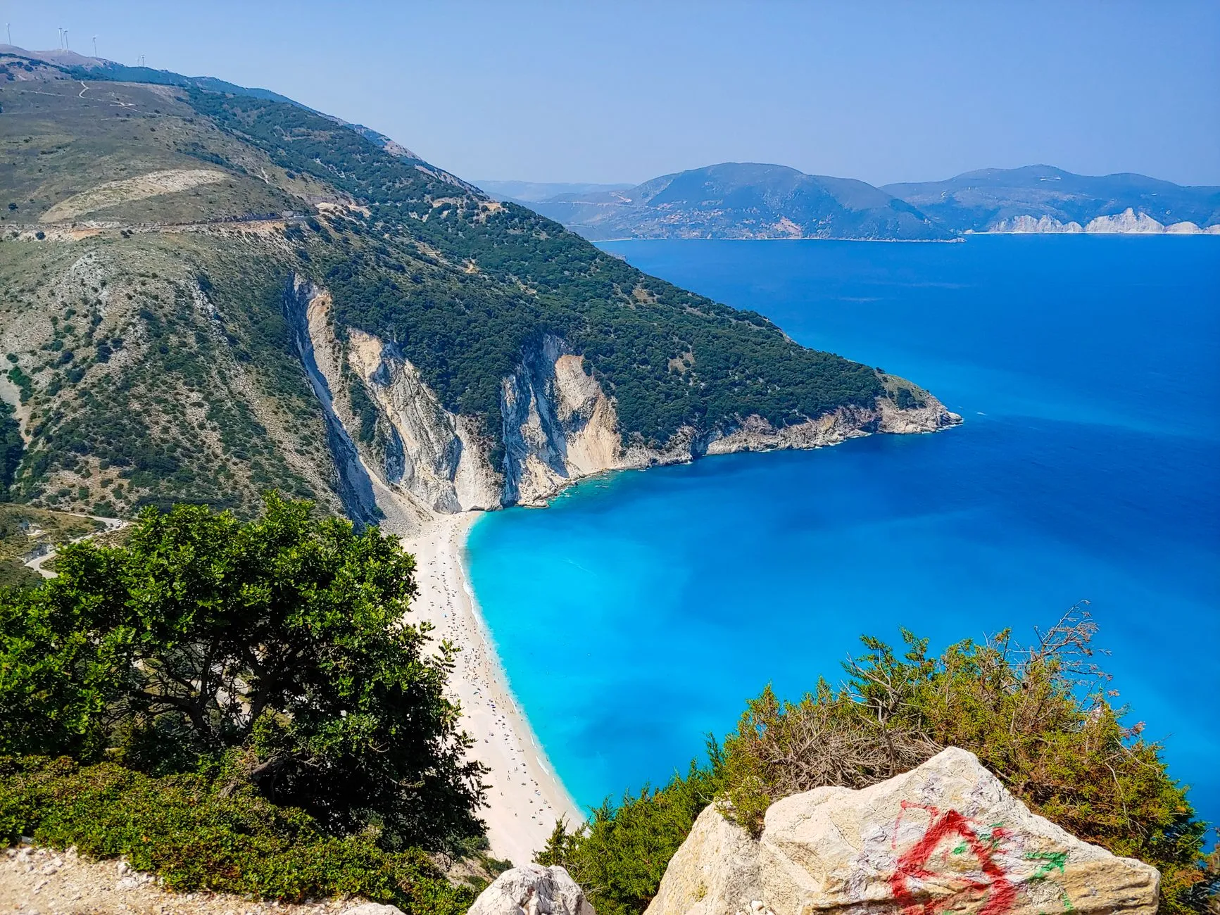 Kefalonia, Greece — Stunning aerial view of Myrtos Beach with turquoise waters and rugged cliffs on Kefalonia Island, Greece.
