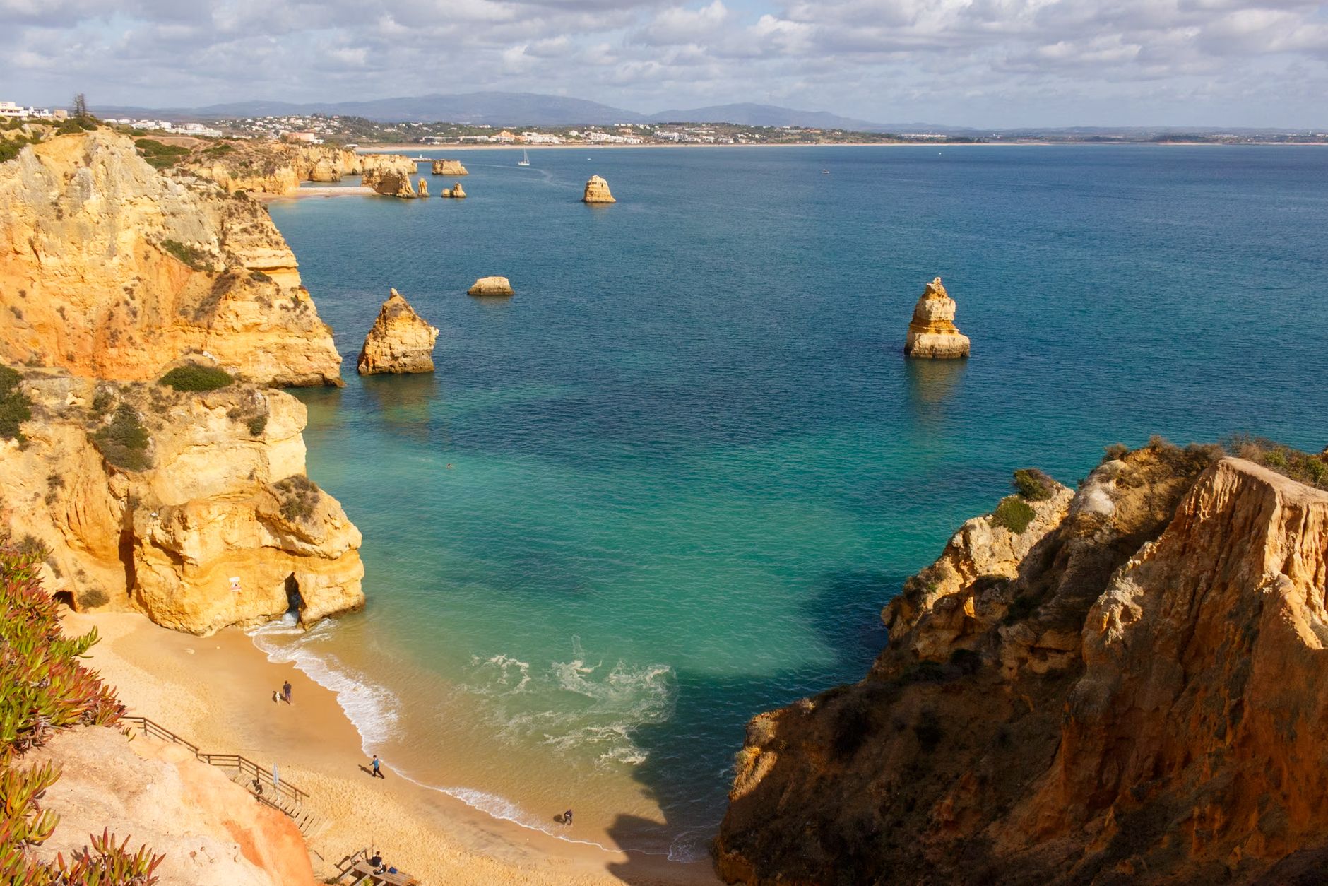 The Algarve, Portugal — Beautiful aerial view of Praia do Camilo, Lagos, with golden cliffs and turquoise waters in Algarve, Portugal.